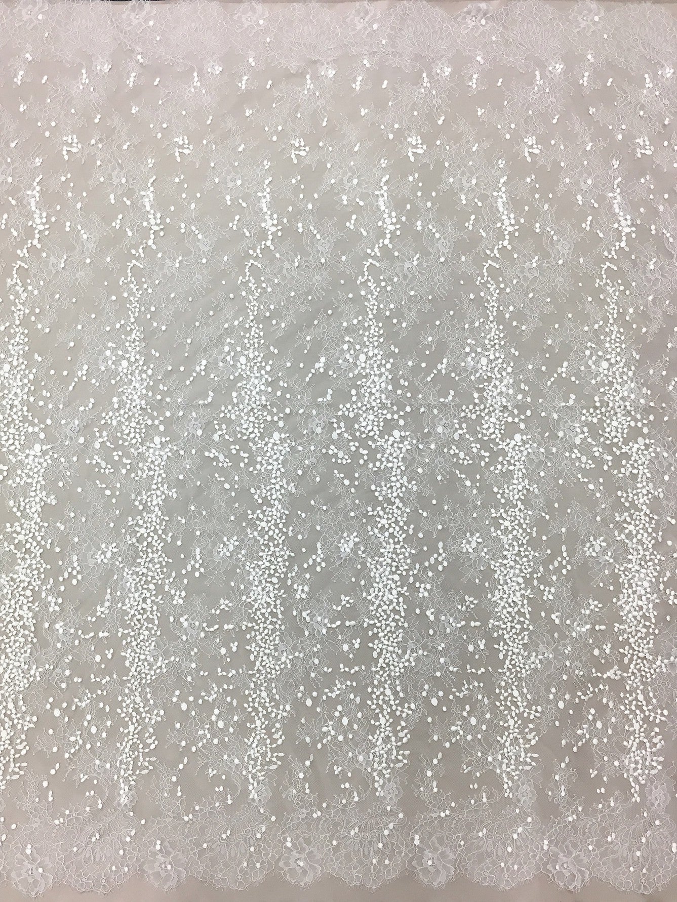 Ivory Embroidered Lace — featuring scalloped edges, eyelash detail and floral motifs, in nylon and viscose, 130cm wide
