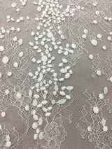 Ivory Embroidered Lace — featuring scalloped edges, eyelash detail and floral motifs, in nylon and viscose, 130cm wide