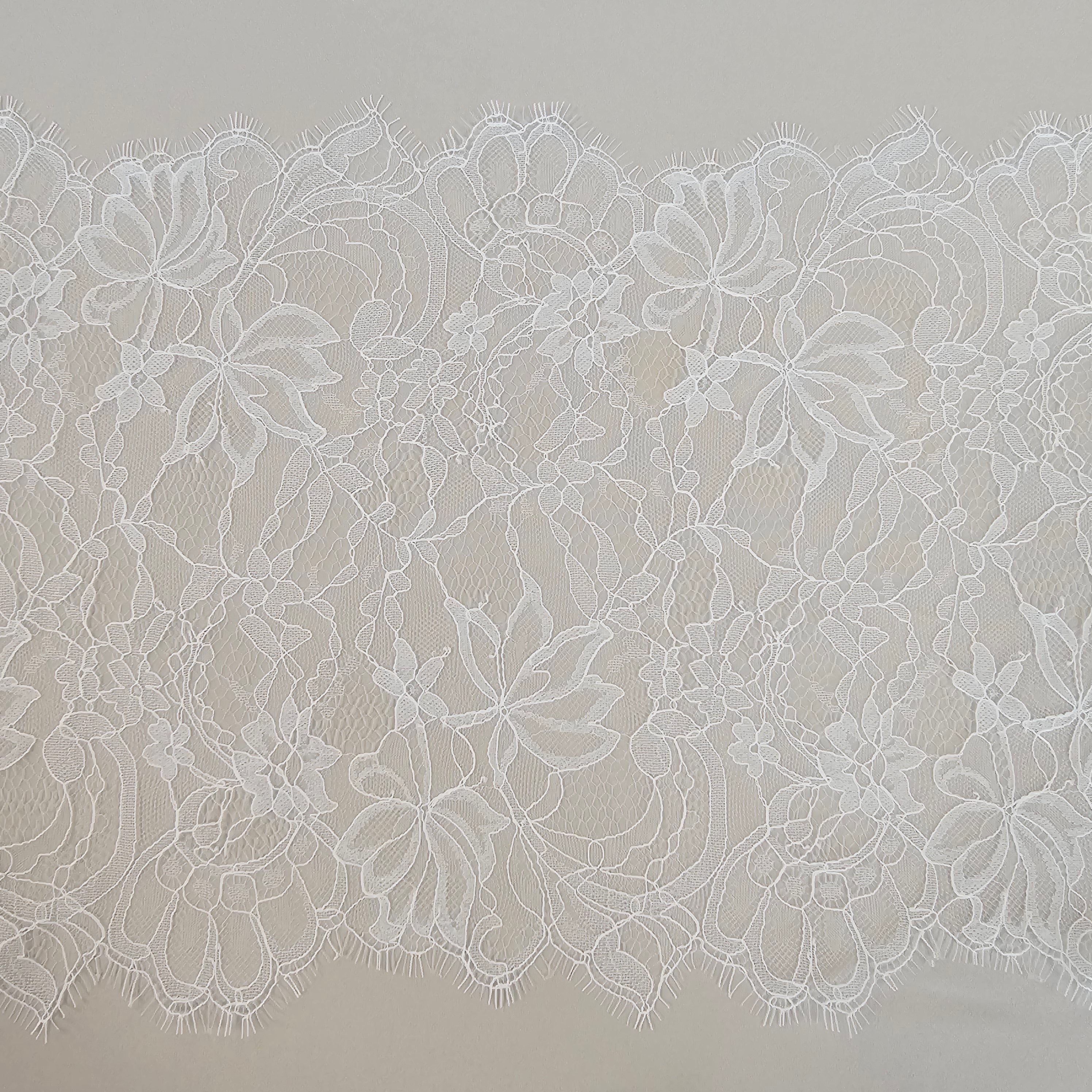 Ivory Fine lace trim — featuring scalloped edges, eyelash detail and floral motifs, in nylon and viscose, 27cm wide