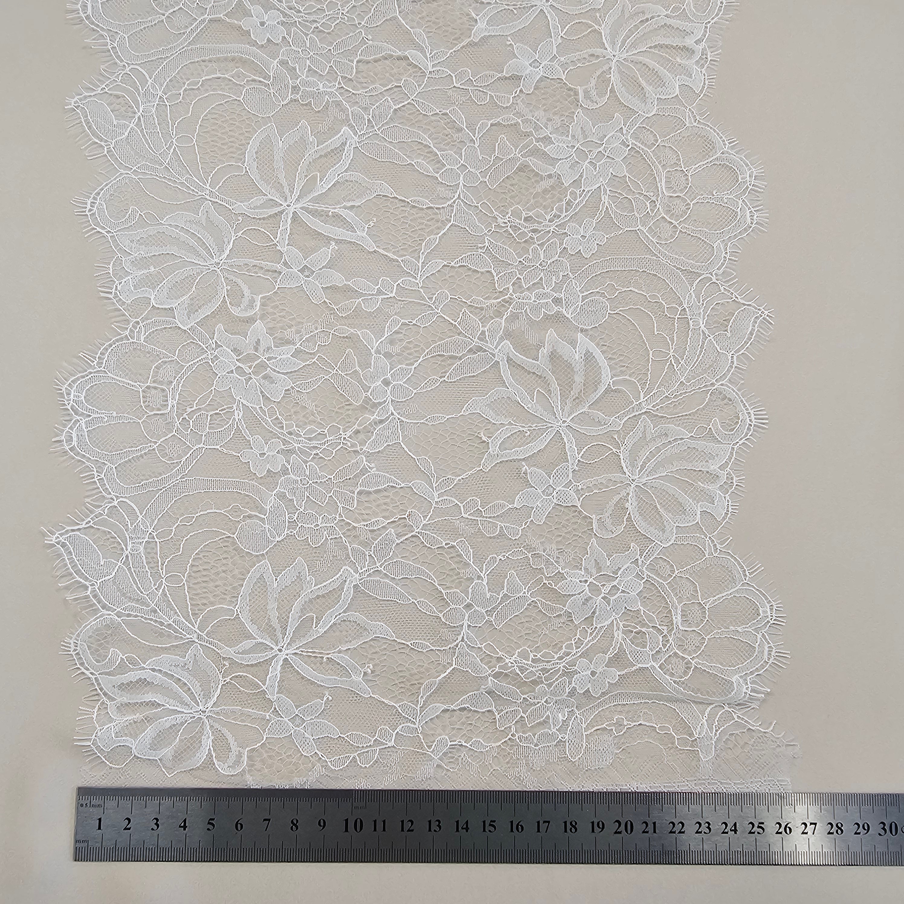 Ivory Fine lace trim — featuring scalloped edges, eyelash detail and floral motifs, in nylon and viscose, 27cm wide
