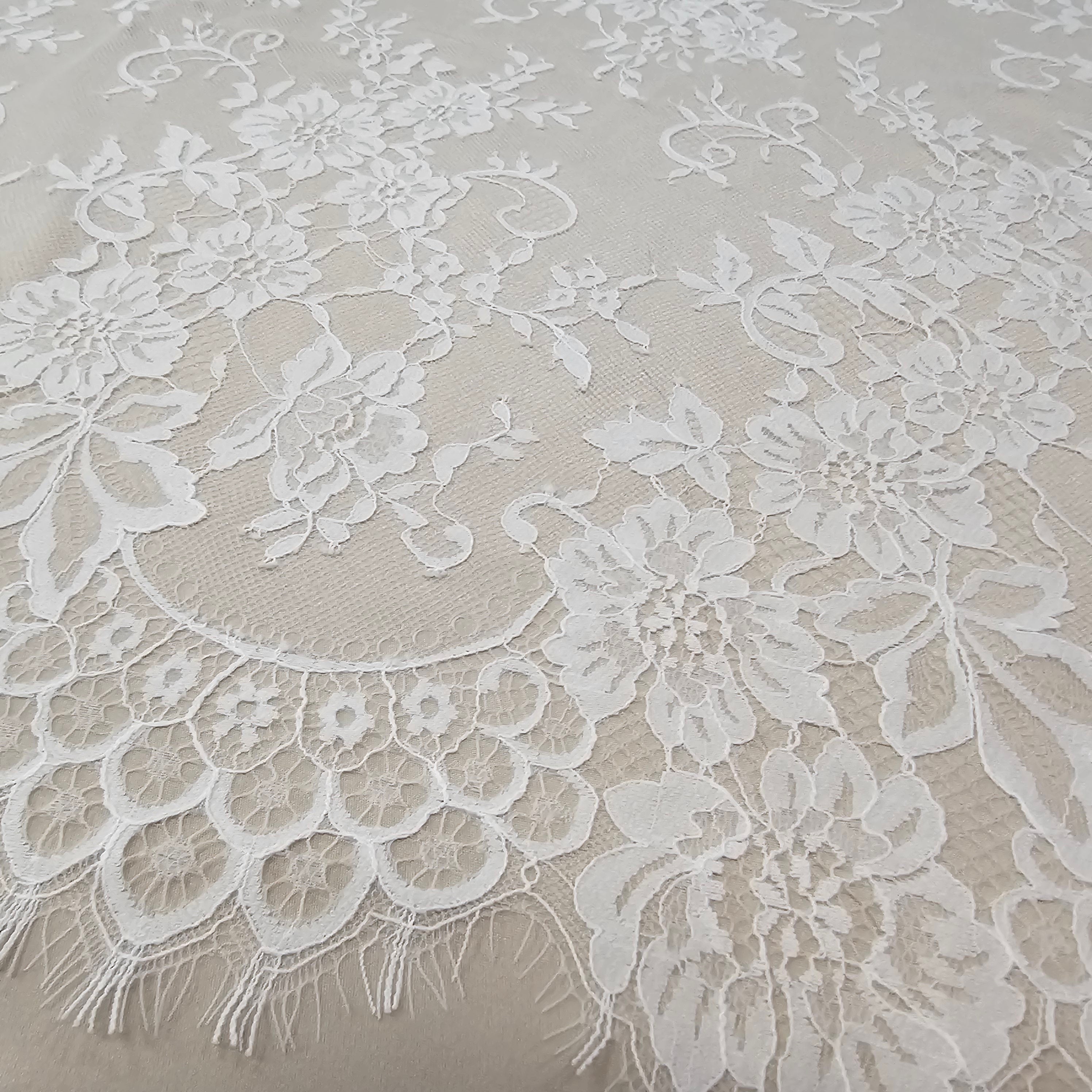 Ivory Fine Floral Lace — featuring scalloped edges and floral motifs, 130cm wide