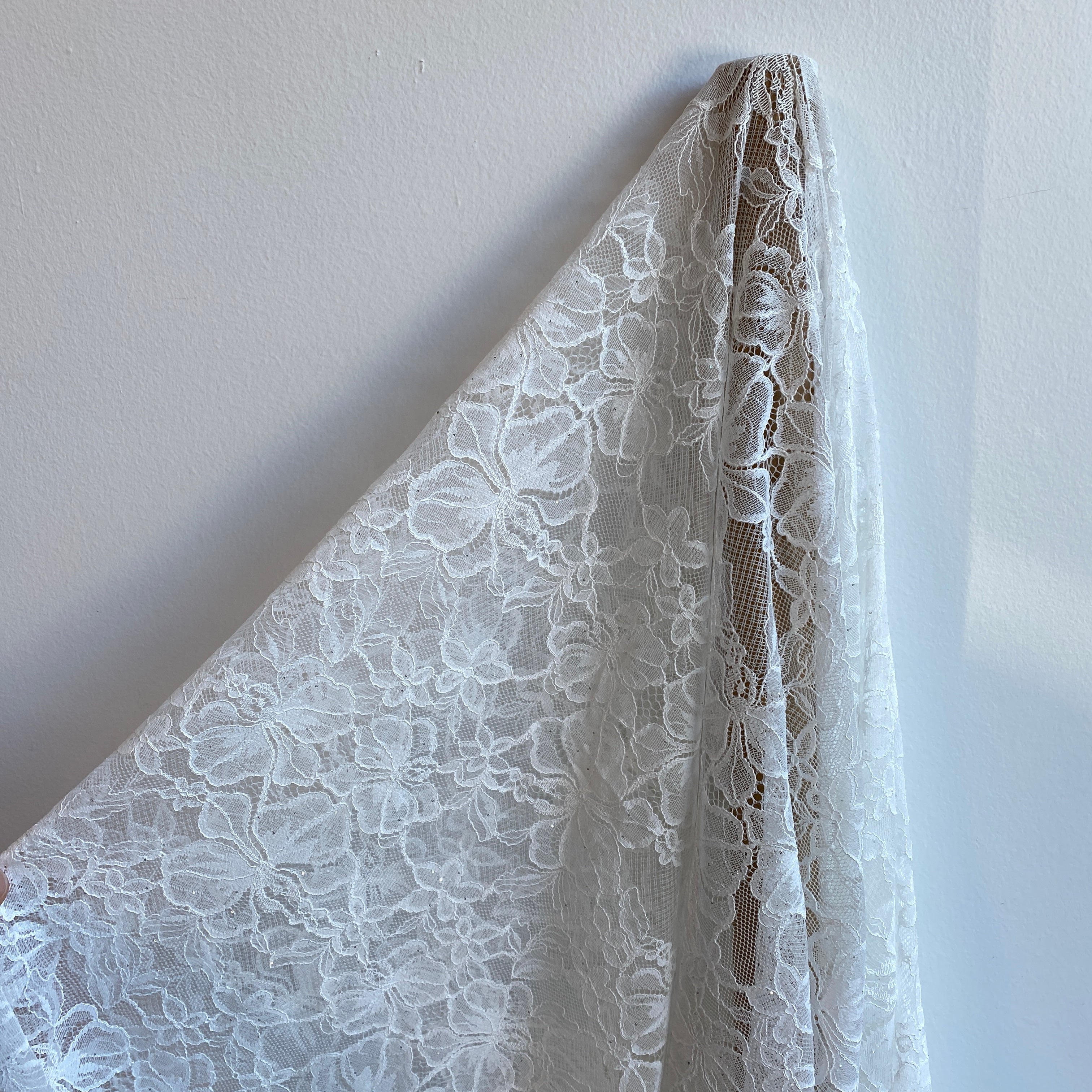 Ivory Glitter Floral Lace — featuring scalloped edges and floral motifs, in nylon, 140cm wide