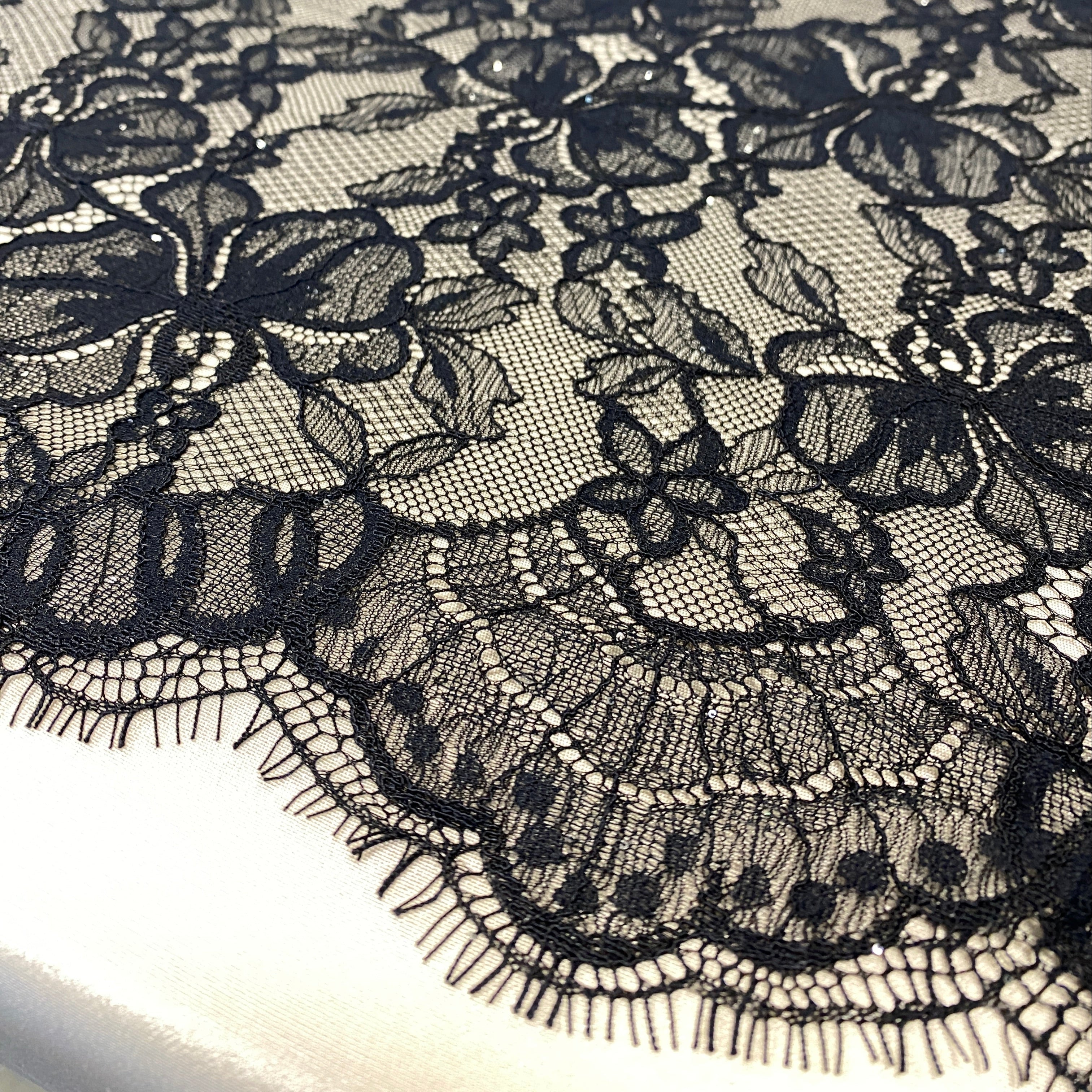 Black Glitter Floral Lace — featuring scalloped edges and floral motifs, in nylon, 160cm wide