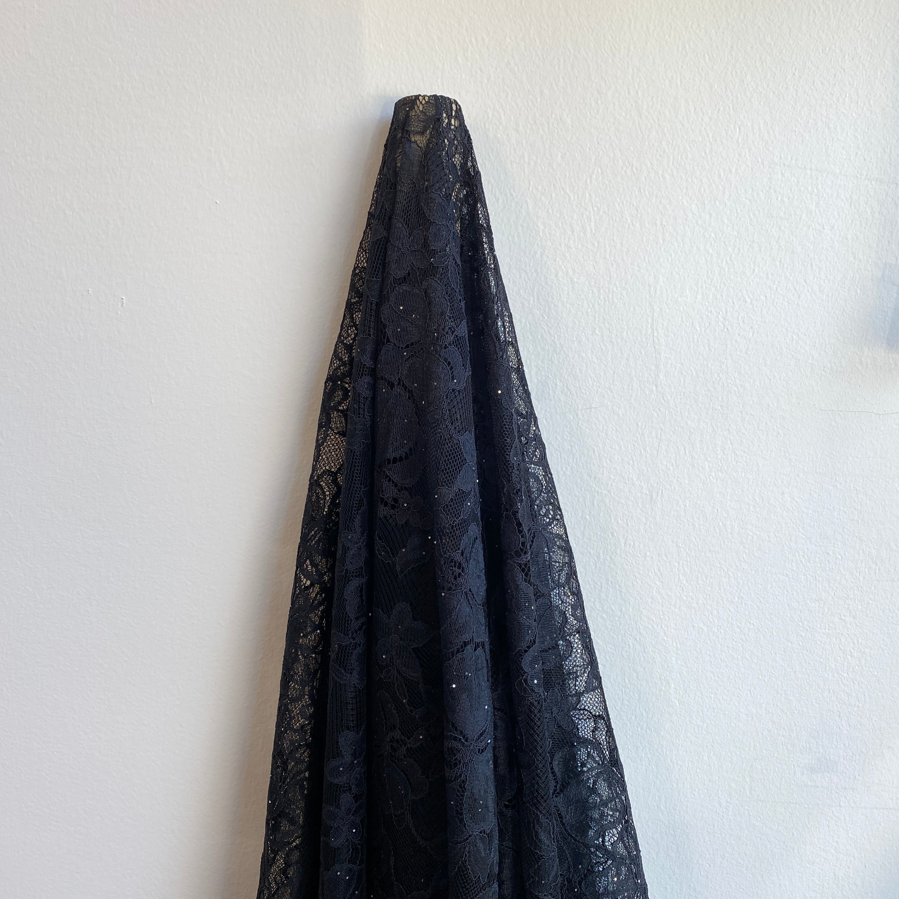Black Glitter Floral Lace — featuring scalloped edges and floral motifs, in nylon, 160cm wide