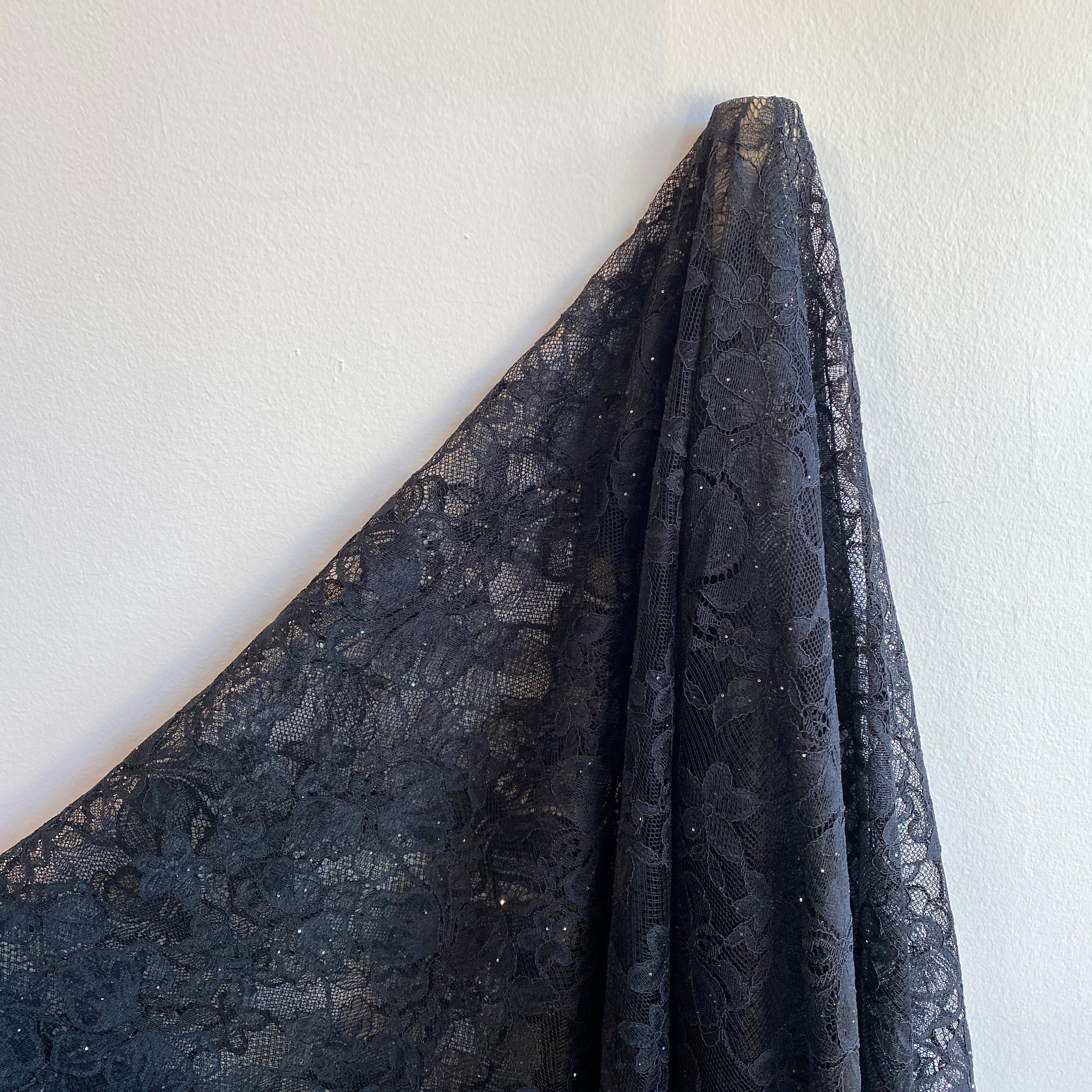 Black Glitter Floral Lace — featuring scalloped edges and floral motifs, in nylon, 160cm wide