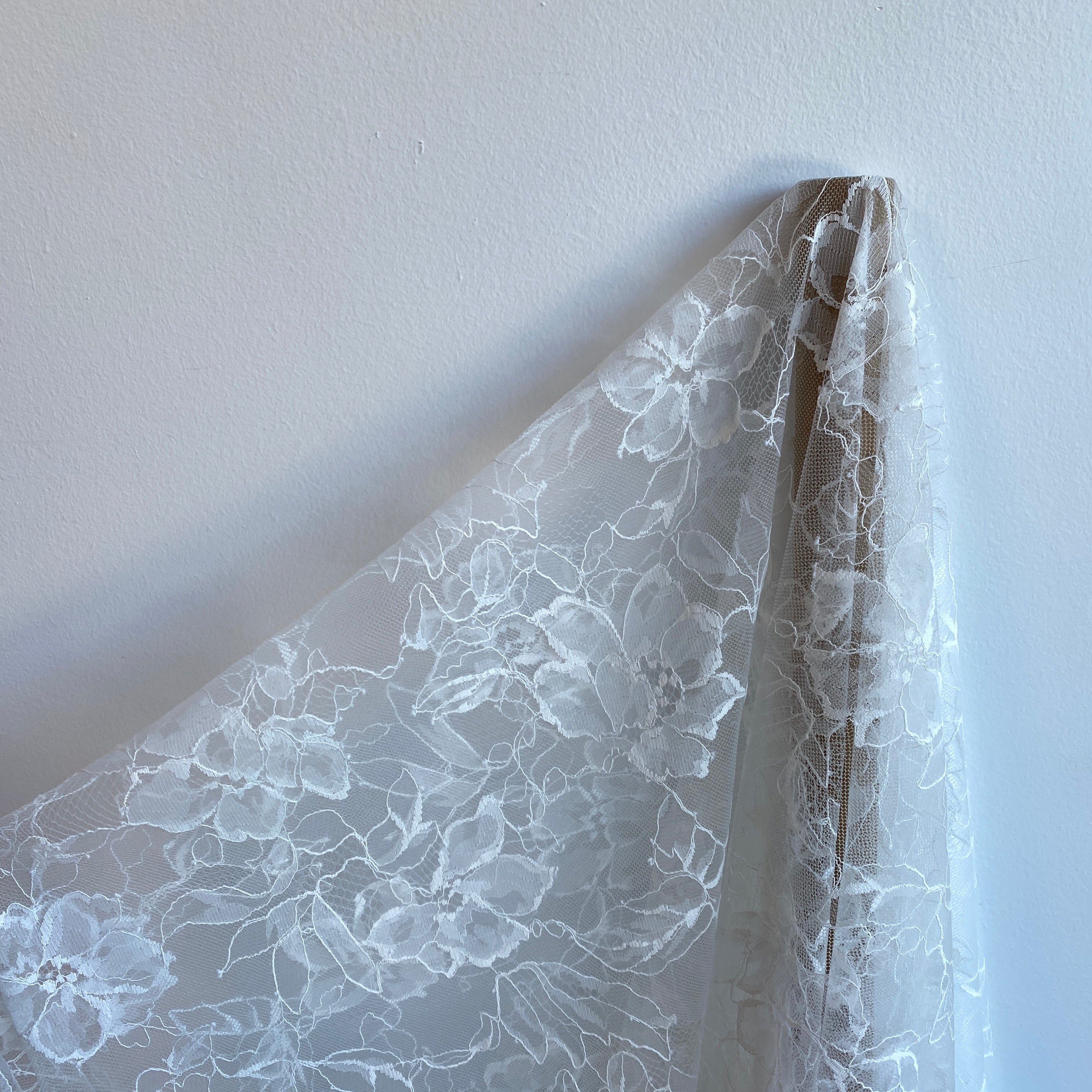 Ivory Floral Lace — featuring scalloped edges, eyelash detail and floral motifs, in nylon, 140cm wide