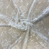Ivory Floral Lace — featuring scalloped edges, eyelash detail and floral motifs, in nylon, 140cm wide