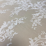 Ivory Floral Lace — featuring scalloped edges, eyelash detail and floral motifs, in nylon, 150cm wide