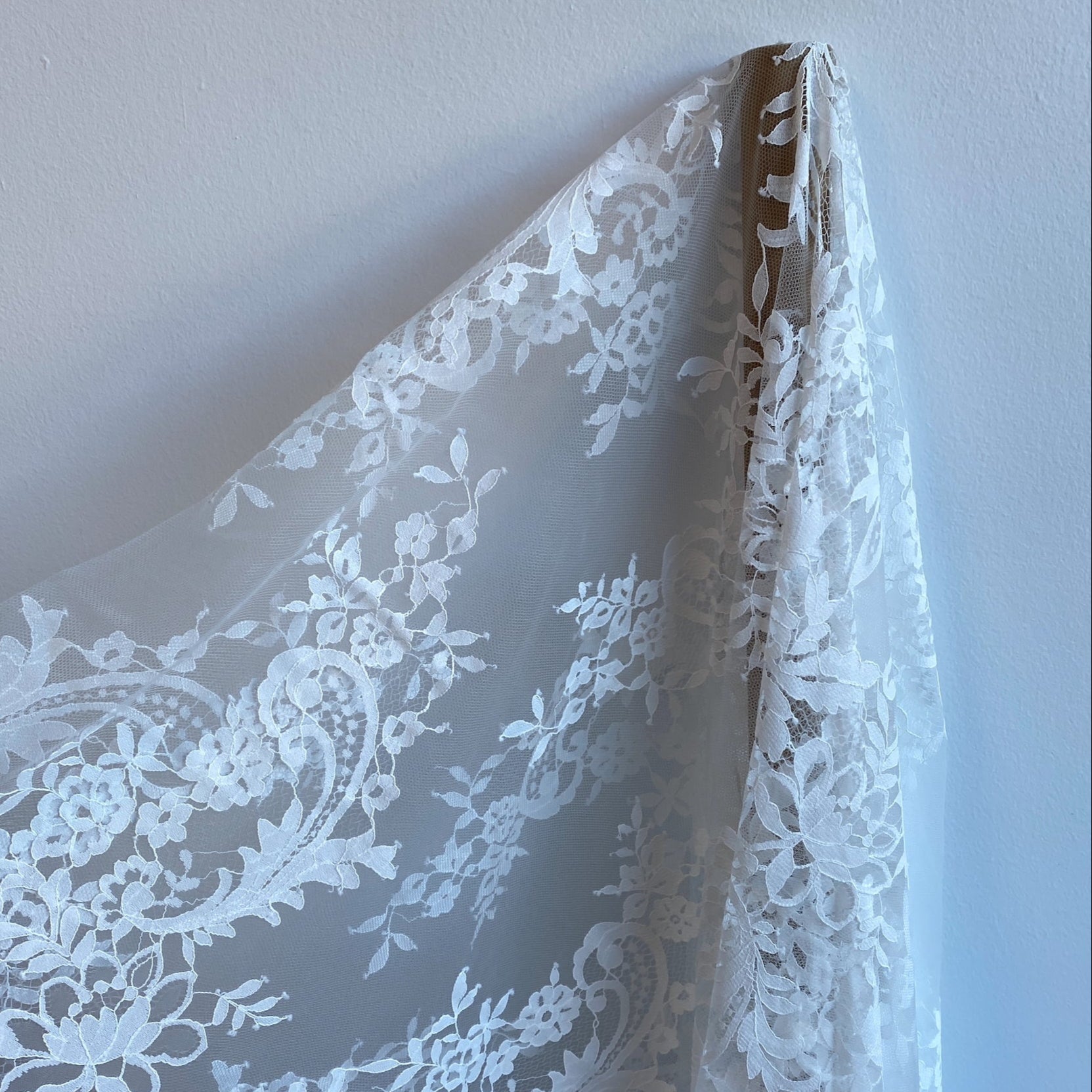 Ivory Floral Lace — featuring scalloped edges, eyelash detail and floral motifs, in nylon, 150cm wide