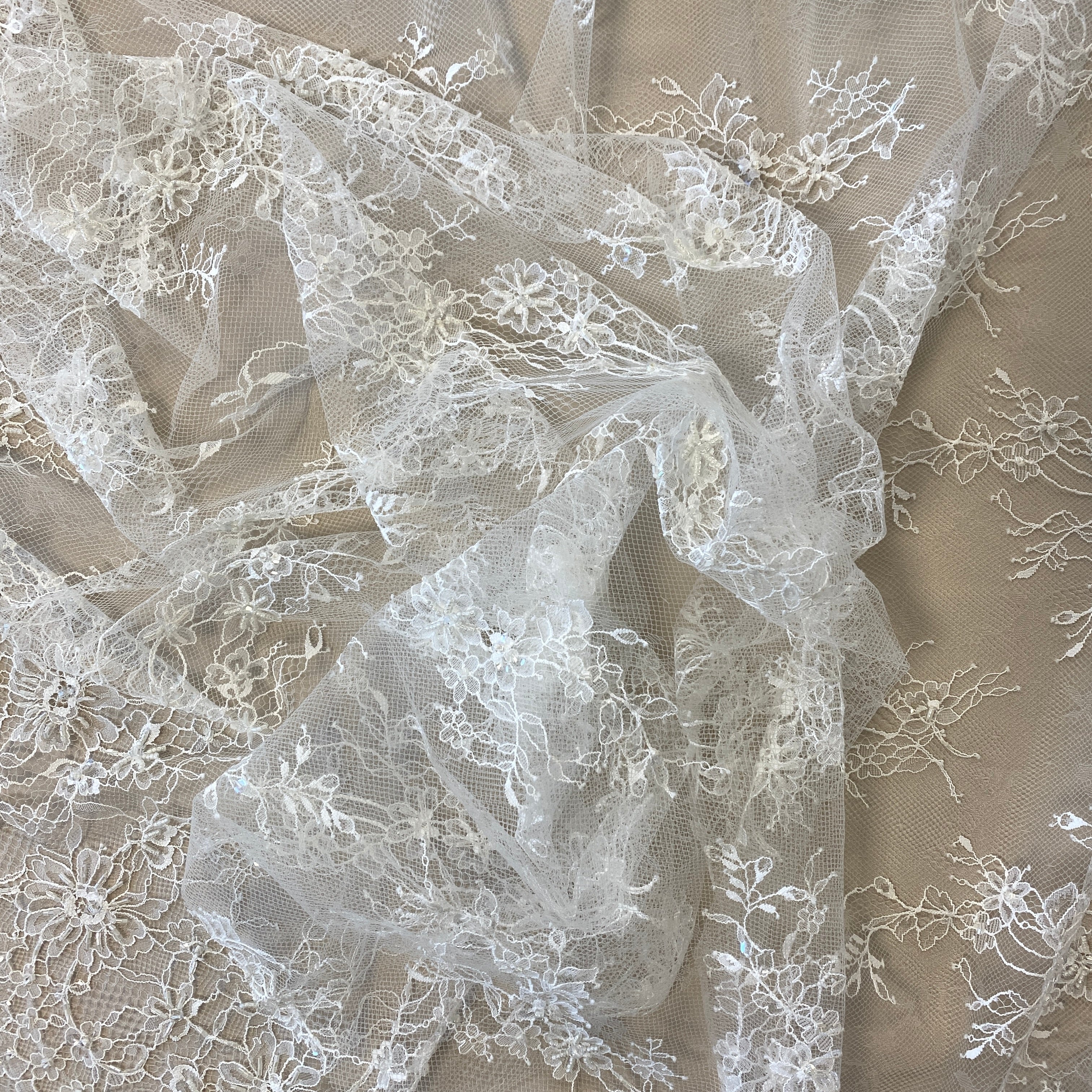 Ivory Beaded Fine Lace — featuring scalloped edges, eyelash detail and floral motifs, in nylon, 150cm wide