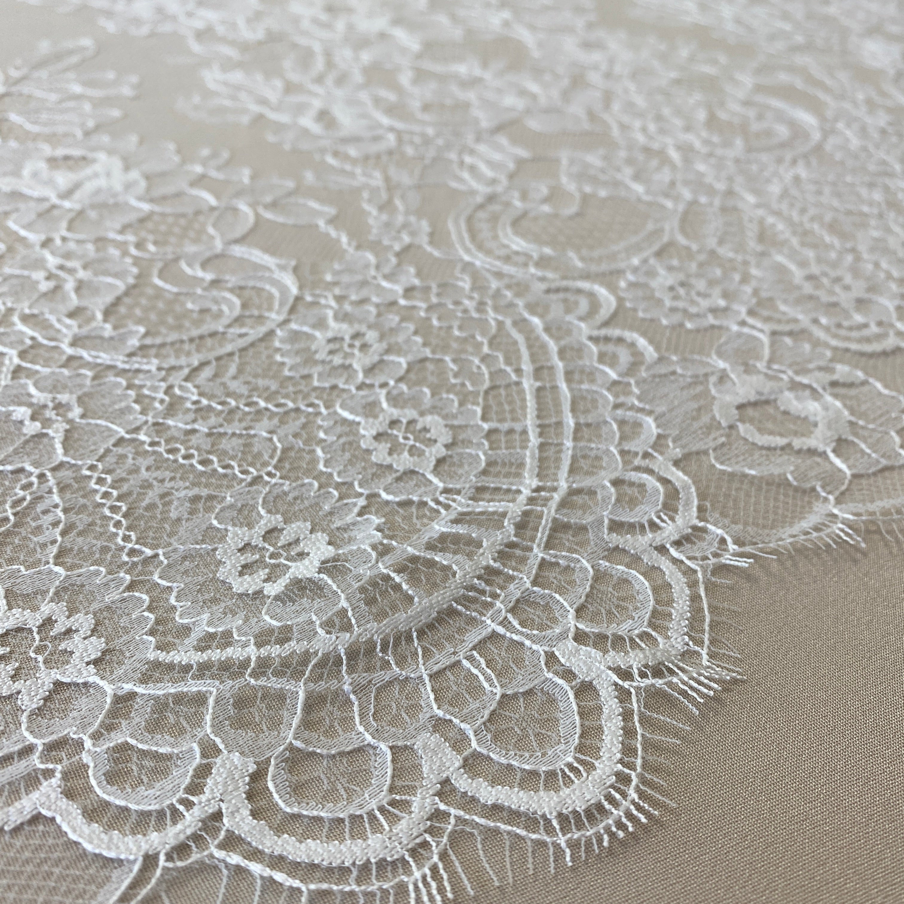 Ivory Fine Lace — featuring scalloped edges and floral motifs, 140cm wide