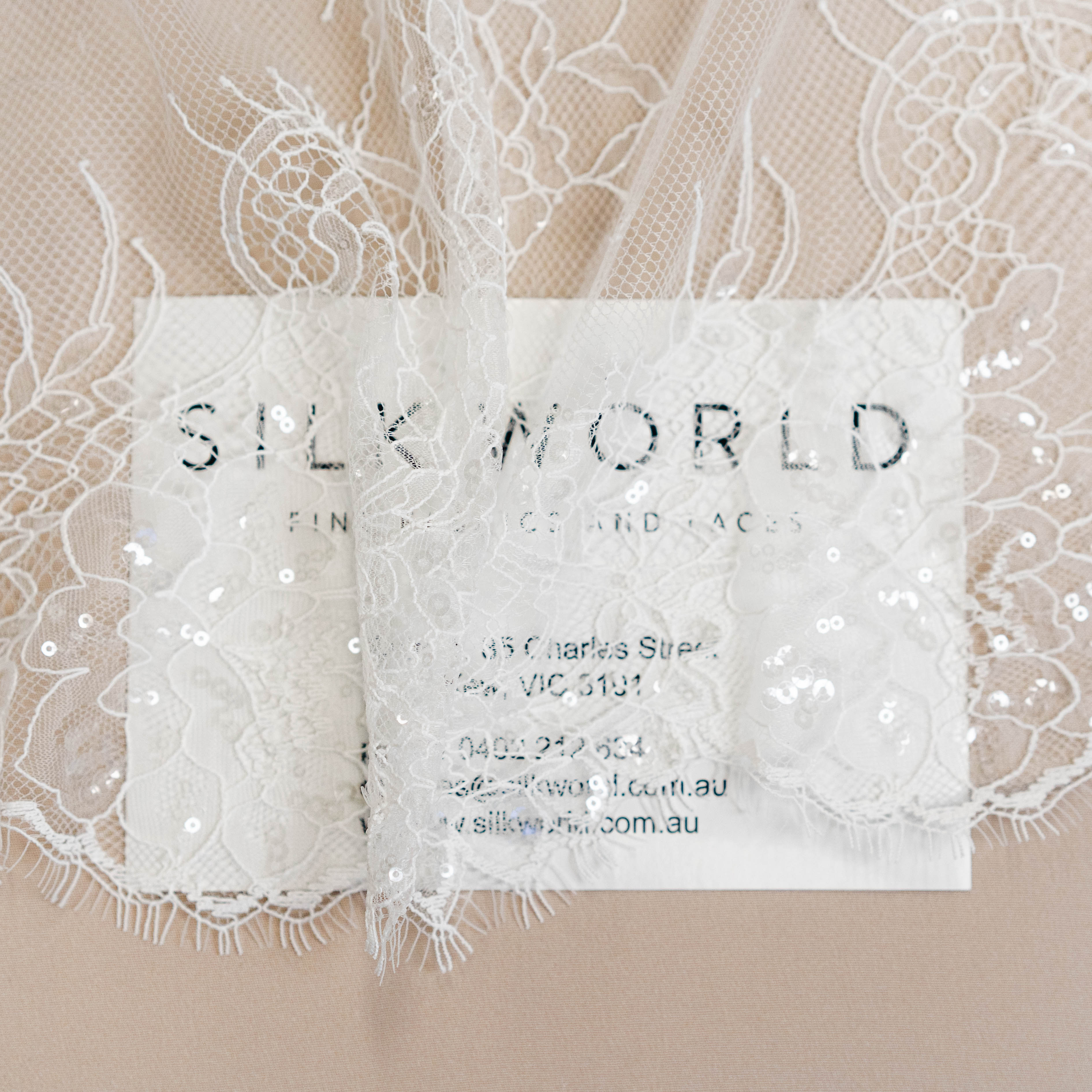 Ivory Beaded Lace — featuring scalloped edges, floral motifs and hand-beading, in nylon and viscose, 130cm wide