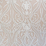 Close-up of intricate white lace pattern on a beige background