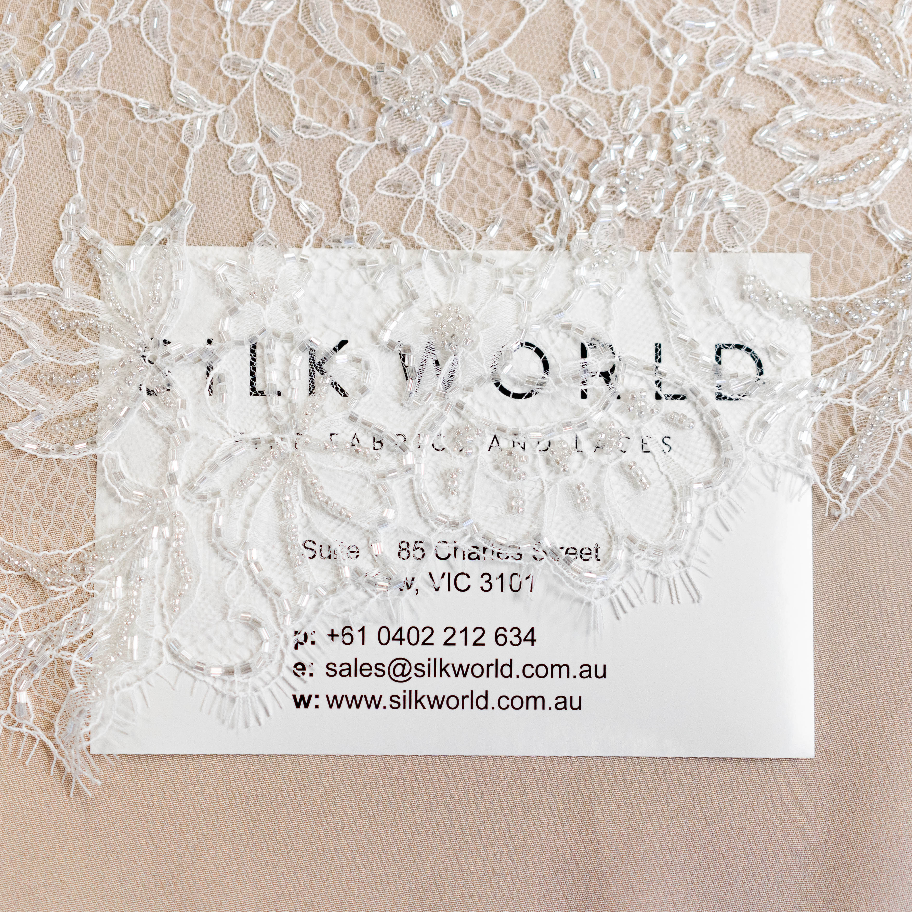 Light Ivory Floriated Beaded Lace Trim — featuring scalloped edges, eyelash detail and floral motifs, in nylon, 30cm wide