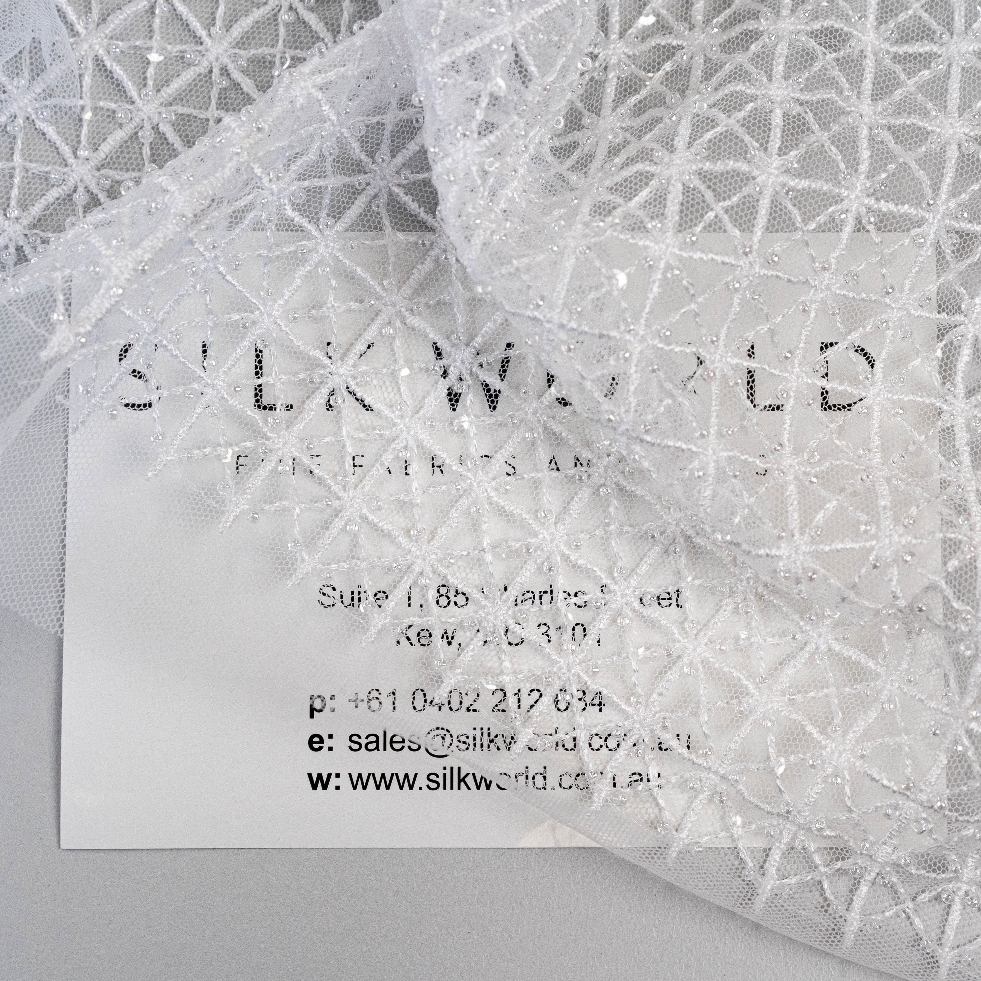 White Lattice Embroidered Tulle — featuring hand-beading and sequins, 50% nylon 50% rayon, 130cm wide