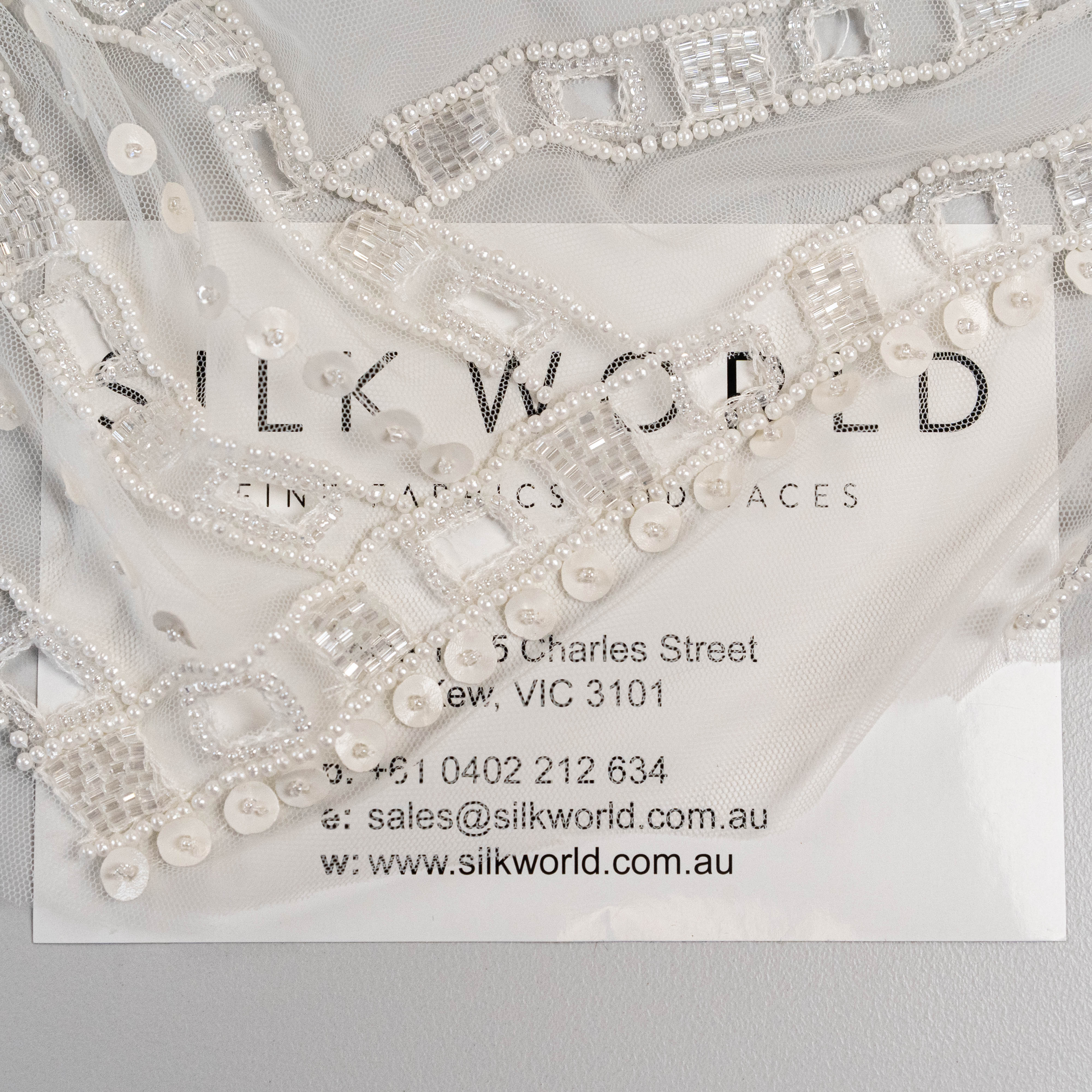 Ivory Cutwork Beaded Tulle — featuring hand-beading and sequins, 100% nylon, 140cm wide
