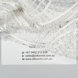 Ivory Embellished Tulle — featuring scalloped edges and hand-beading, 50% nylon 50% rayon, 130cm wide