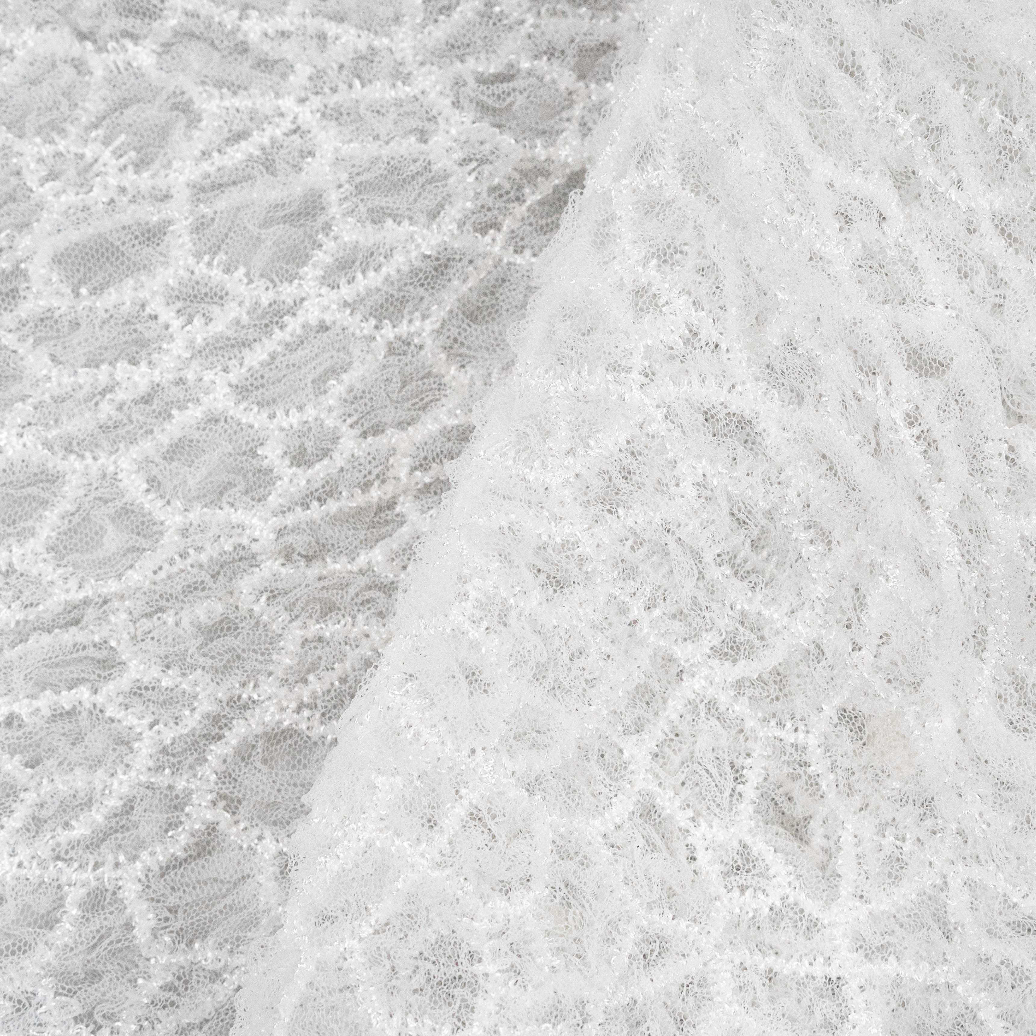 Off White Elastic Crushed Tulle — featuring a crushed texture, 100% nylon, 50cm wide