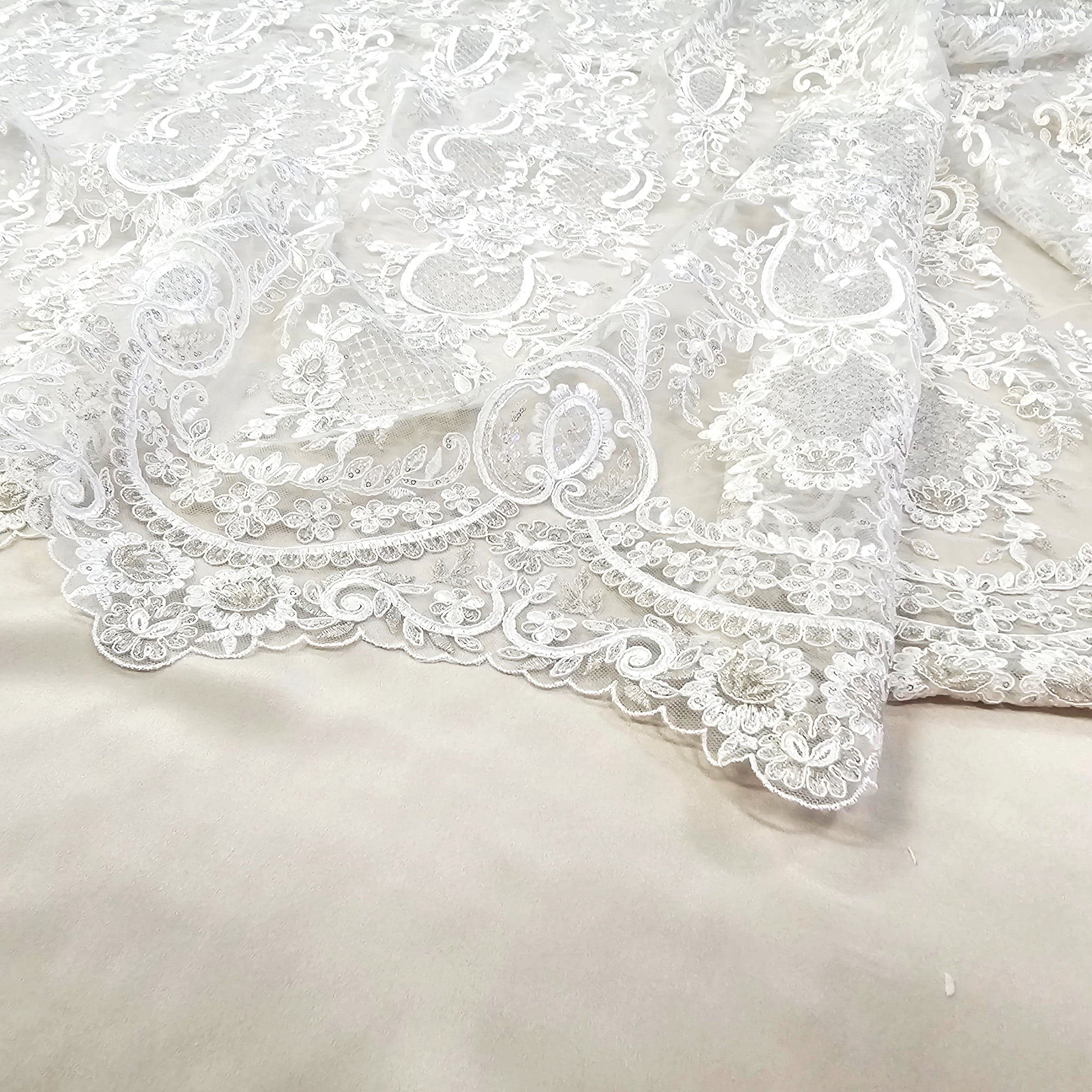 Ivory / Silver Embroidered Corded Tulle — featuring scalloped edges, a corded texture and sequins, 50% nylon 50% rayon, 130cm wide