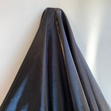 Black Liquid Satin — smooth and glossy with a liquid, wet-look shimmer, 100% polyester, 150cm wide