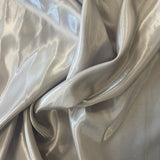 Silver Liquid Satin — smooth and glossy with a liquid, wet-look shimmer, 100% polyester, 150cm wide