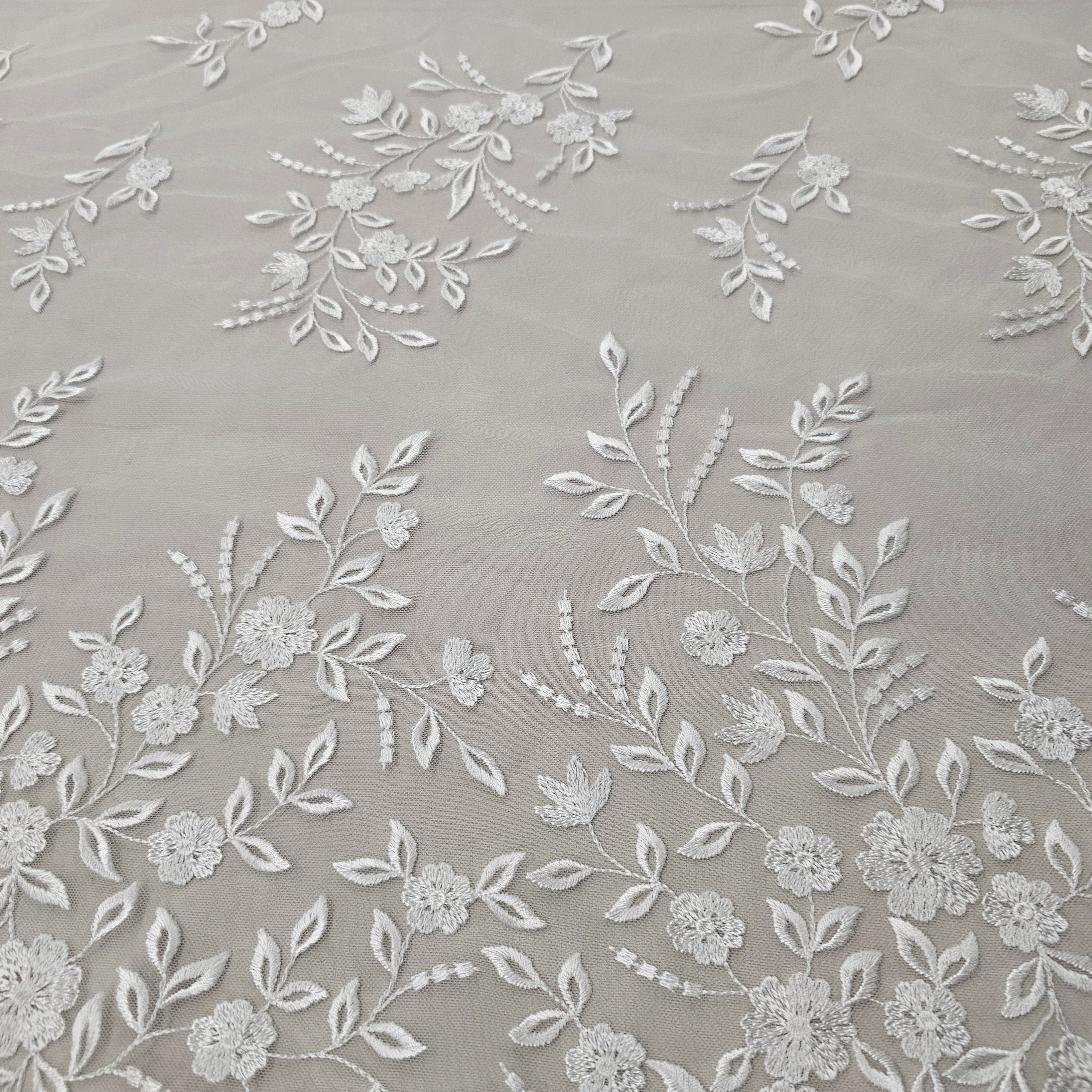 Ivory Embroidered Tulle — featuring a border design, 50% nylon 50% rayon, 135cm wide
