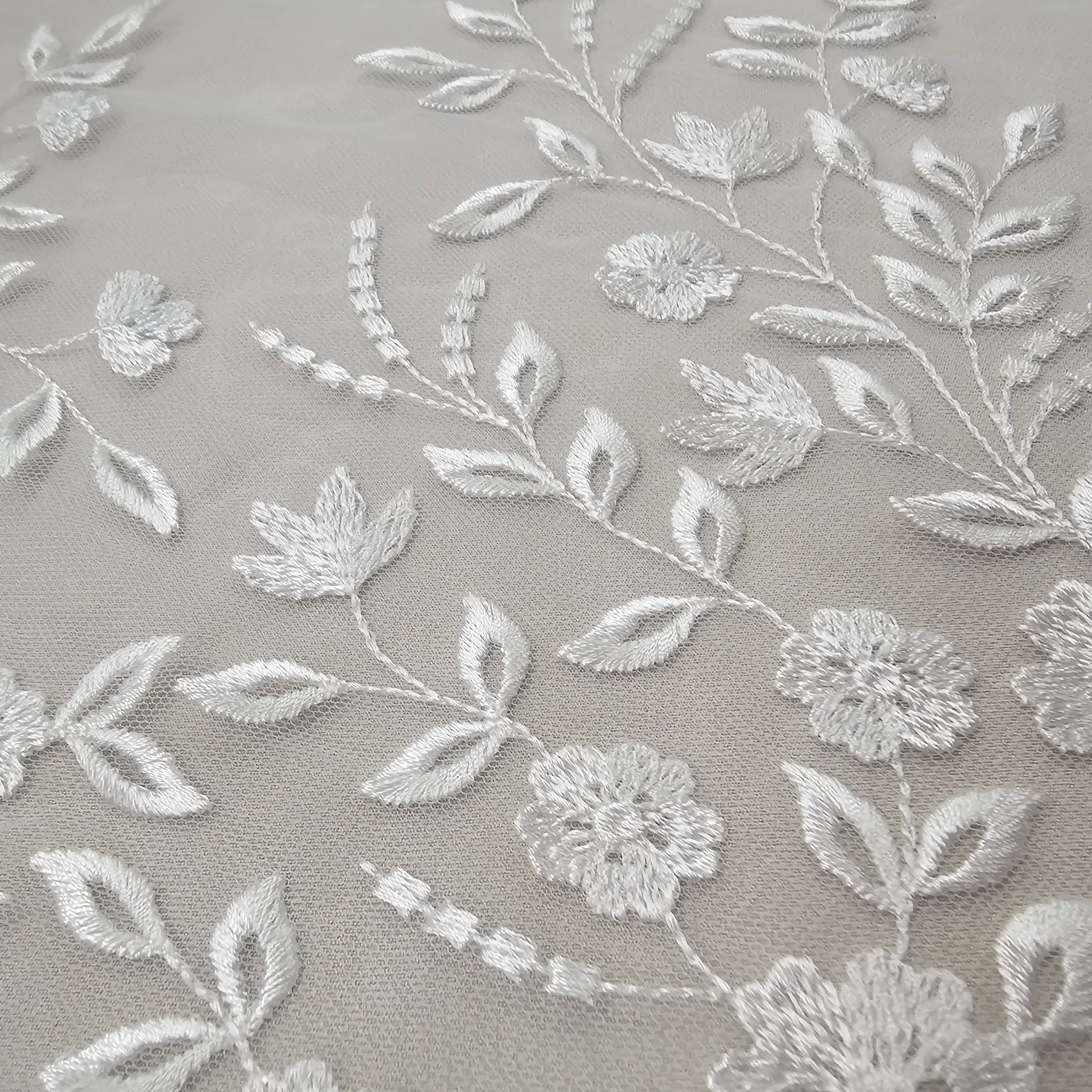 Ivory Embroidered Tulle — featuring a border design, 50% nylon 50% rayon, 135cm wide