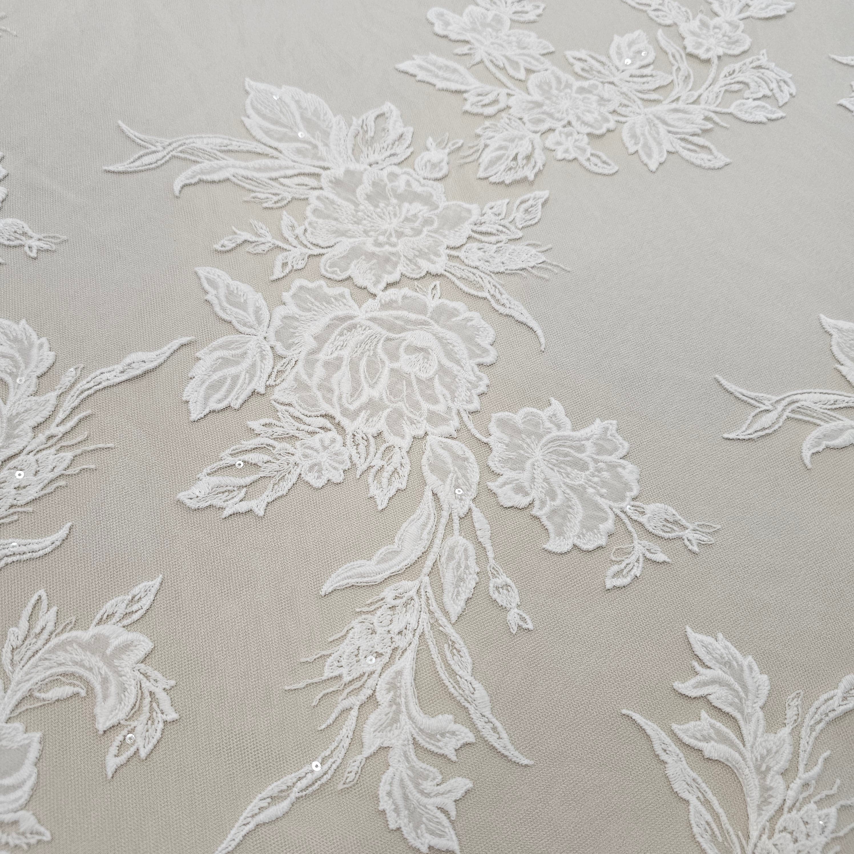 Ivory Floral Embroidered Tulle — featuring floral motifs and a border design, 60% rayon 40% nylon, 140cm wide