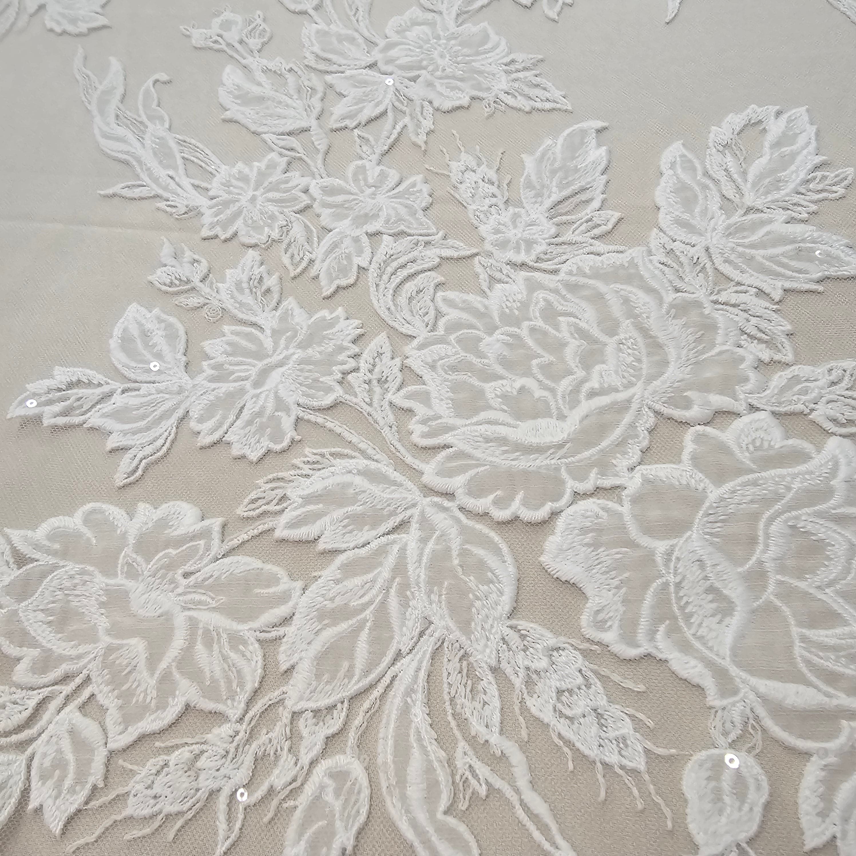 Ivory Floral Embroidered Tulle — featuring floral motifs and a border design, 60% rayon 40% nylon, 140cm wide