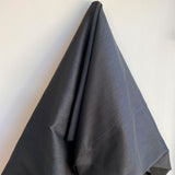 Black Polyester Dupion — mid-weight and crisp with a lightly slubbed texture, 100% polyester, 140cm wide
