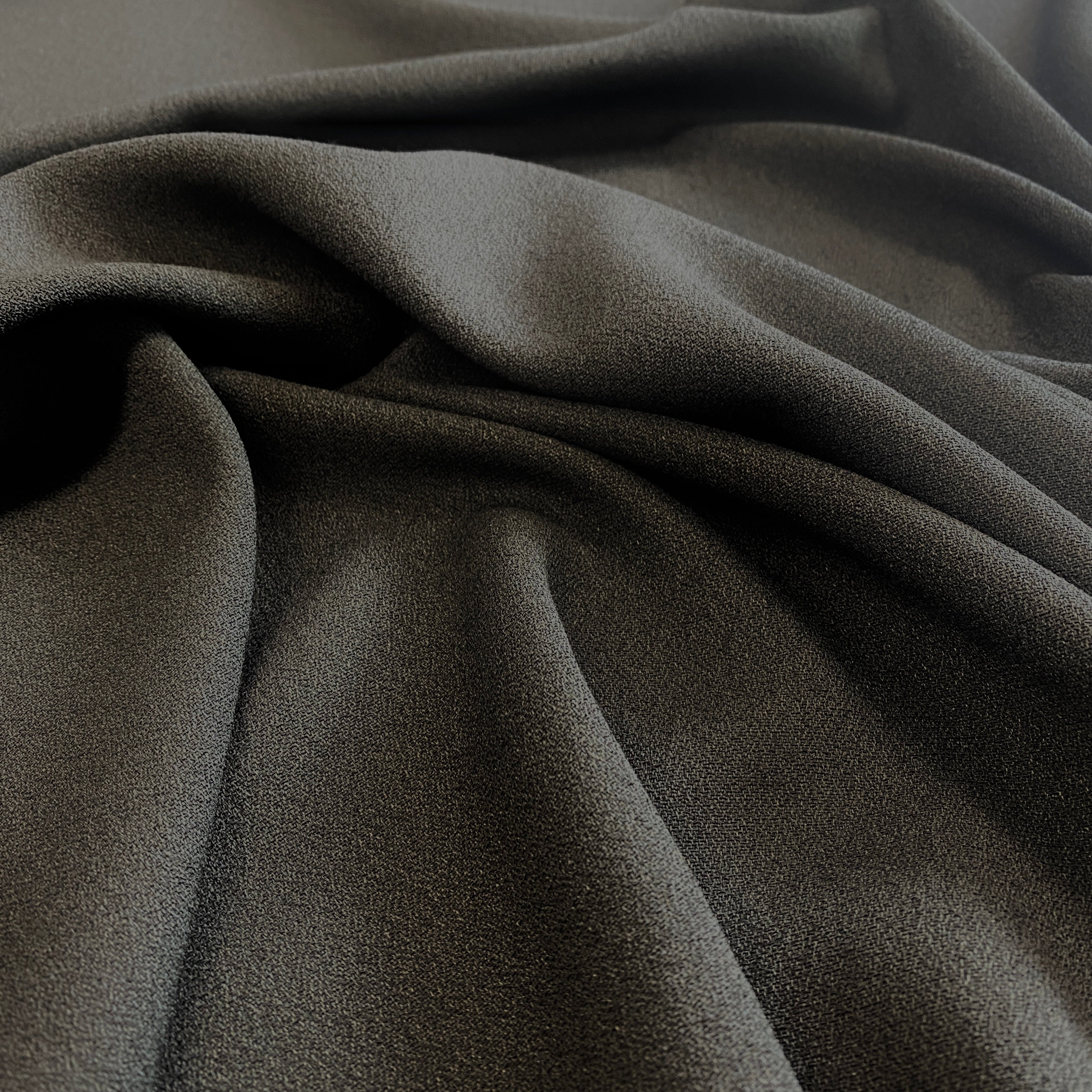 Black Wool Crepe — a medium-weight wool-blend crepe suiting with a soft handle, 137cm wide