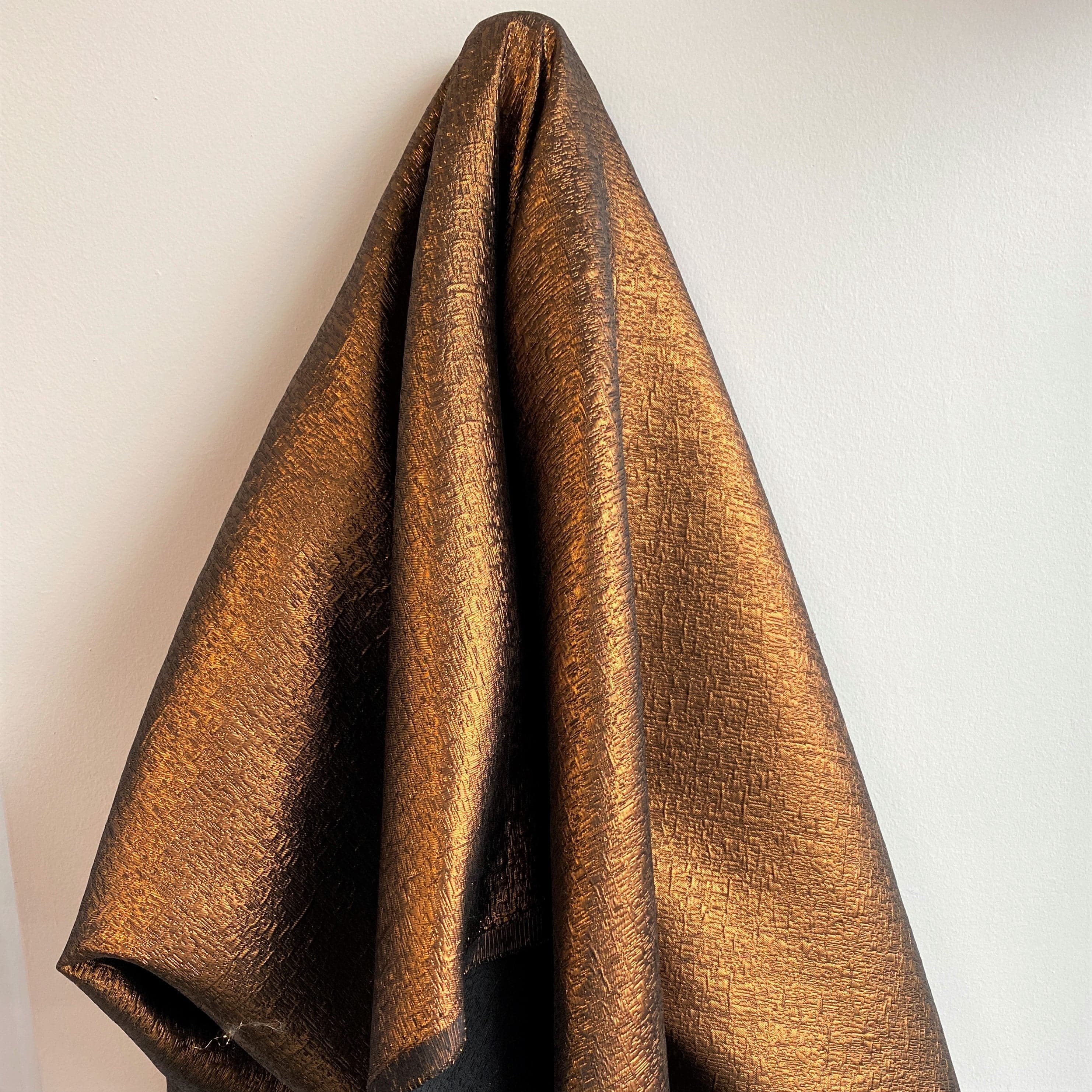Copper Metallic Jacquard — featuring a woven metallic jacquard design with a soft feel and stiff drape, 140cm wide