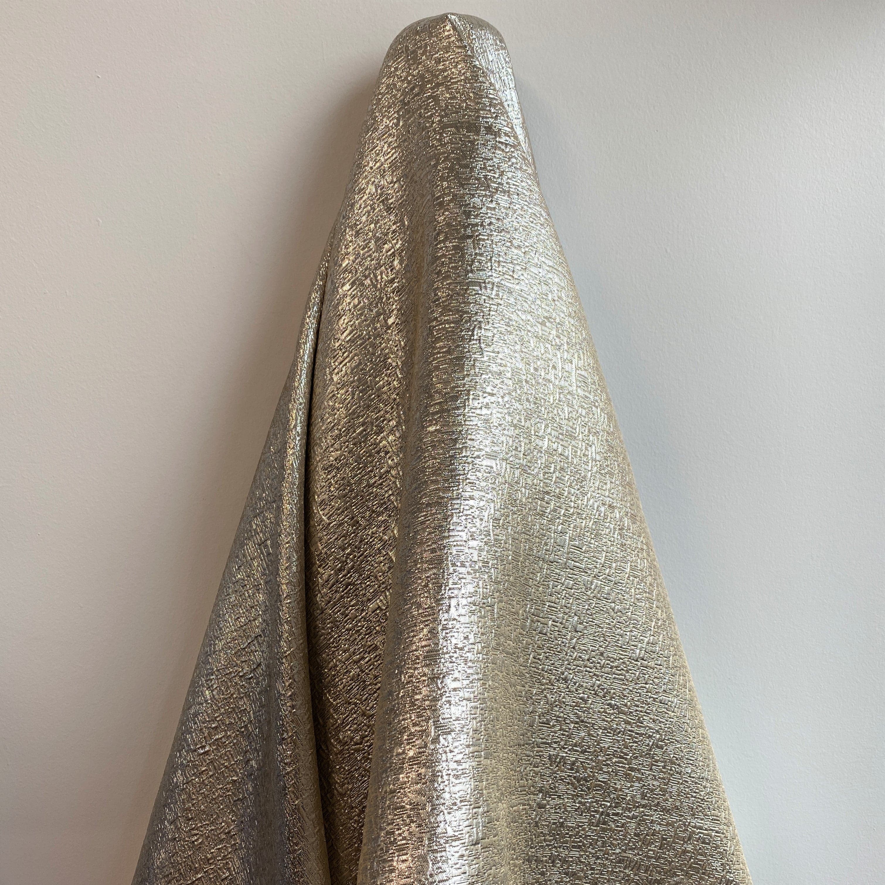 White Gold Metallic Jacquard — featuring a woven metallic jacquard design with a soft feel and stiff drape, 140cm wide