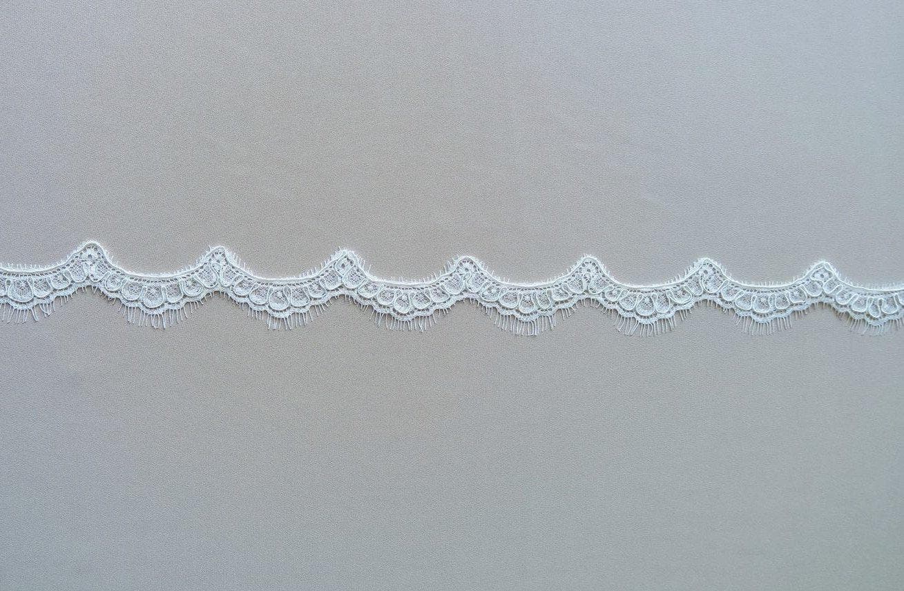Light Ivory Corded Lace Trim — featuring scalloped edges, eyelash detail and floral motifs, in nylon and viscose, 3cm wide