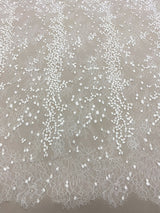 Ivory Embroidered Lace — featuring scalloped edges, eyelash detail and floral motifs, in nylon and viscose, 130cm wide