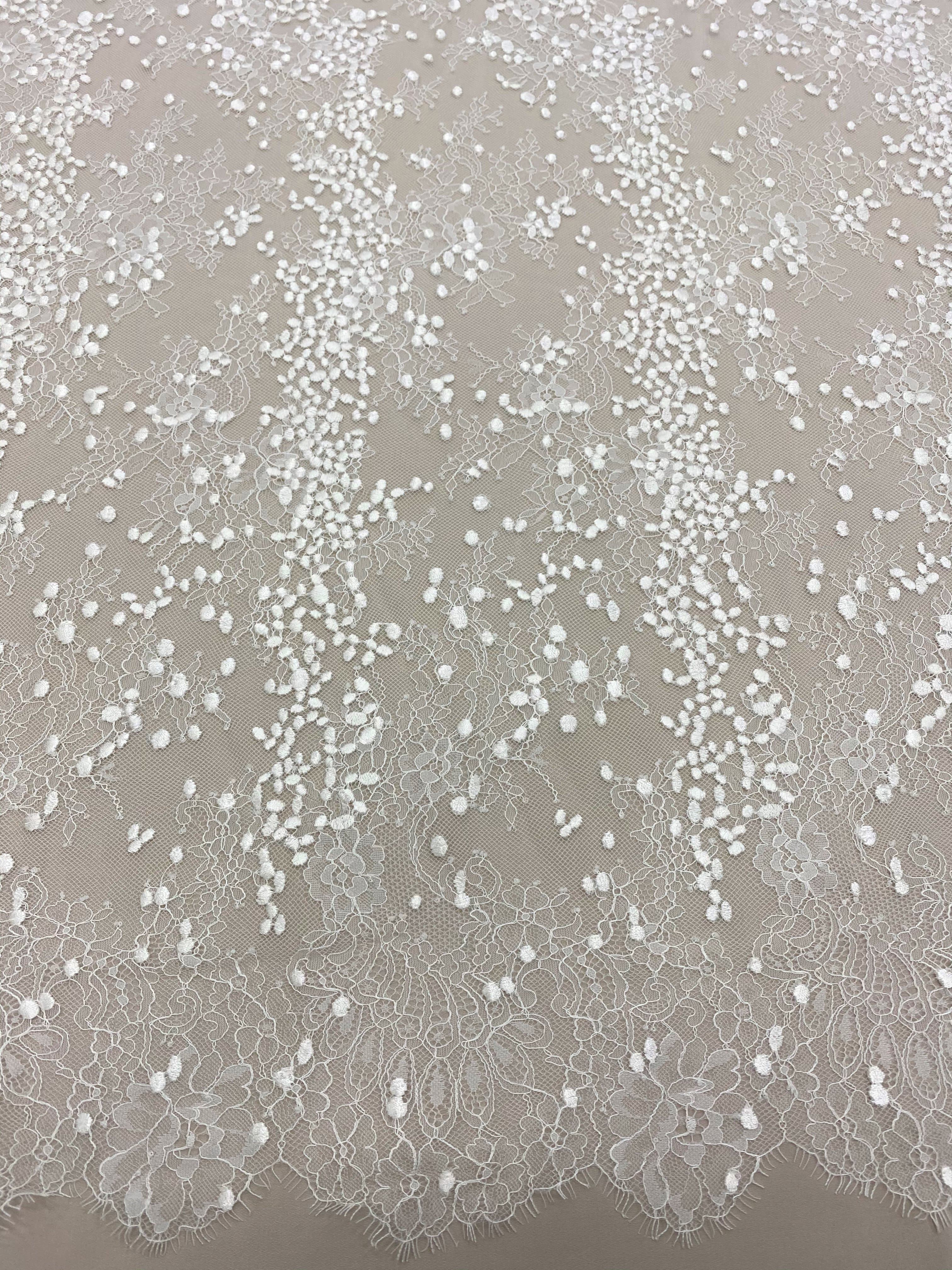 Ivory Embroidered Lace — featuring scalloped edges, eyelash detail and floral motifs, in nylon and viscose, 130cm wide
