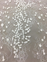 Ivory Embroidered Lace — featuring scalloped edges, eyelash detail and floral motifs, in nylon and viscose, 130cm wide