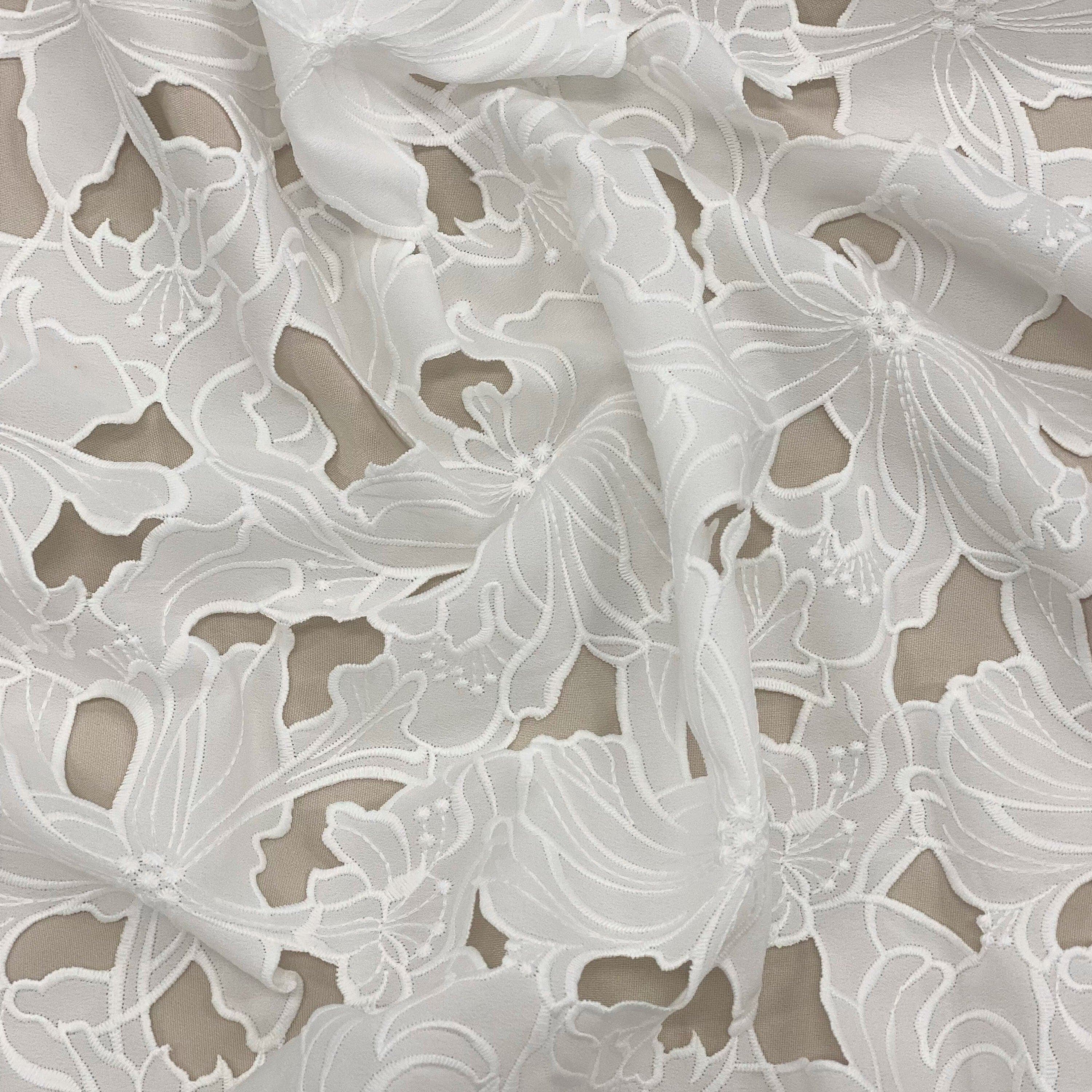 Ivory Embroidered Cutwork — featuring a floral cutwork design, 100% polyester, 130cm wide