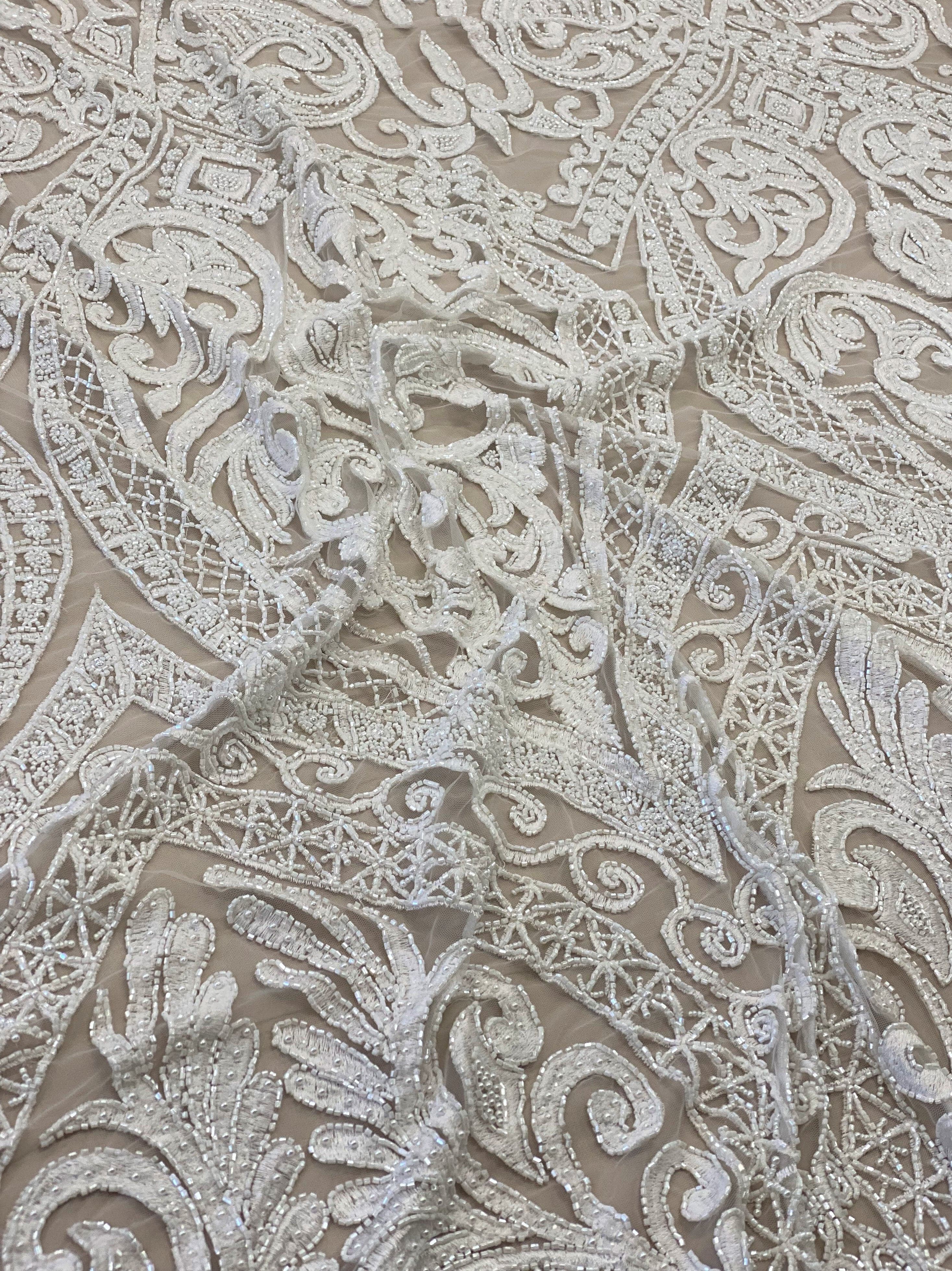 Ivory Embroidered Tulle — featuring scalloped edges and hand-beading, 50% nylon 50% rayon, 135cm wide