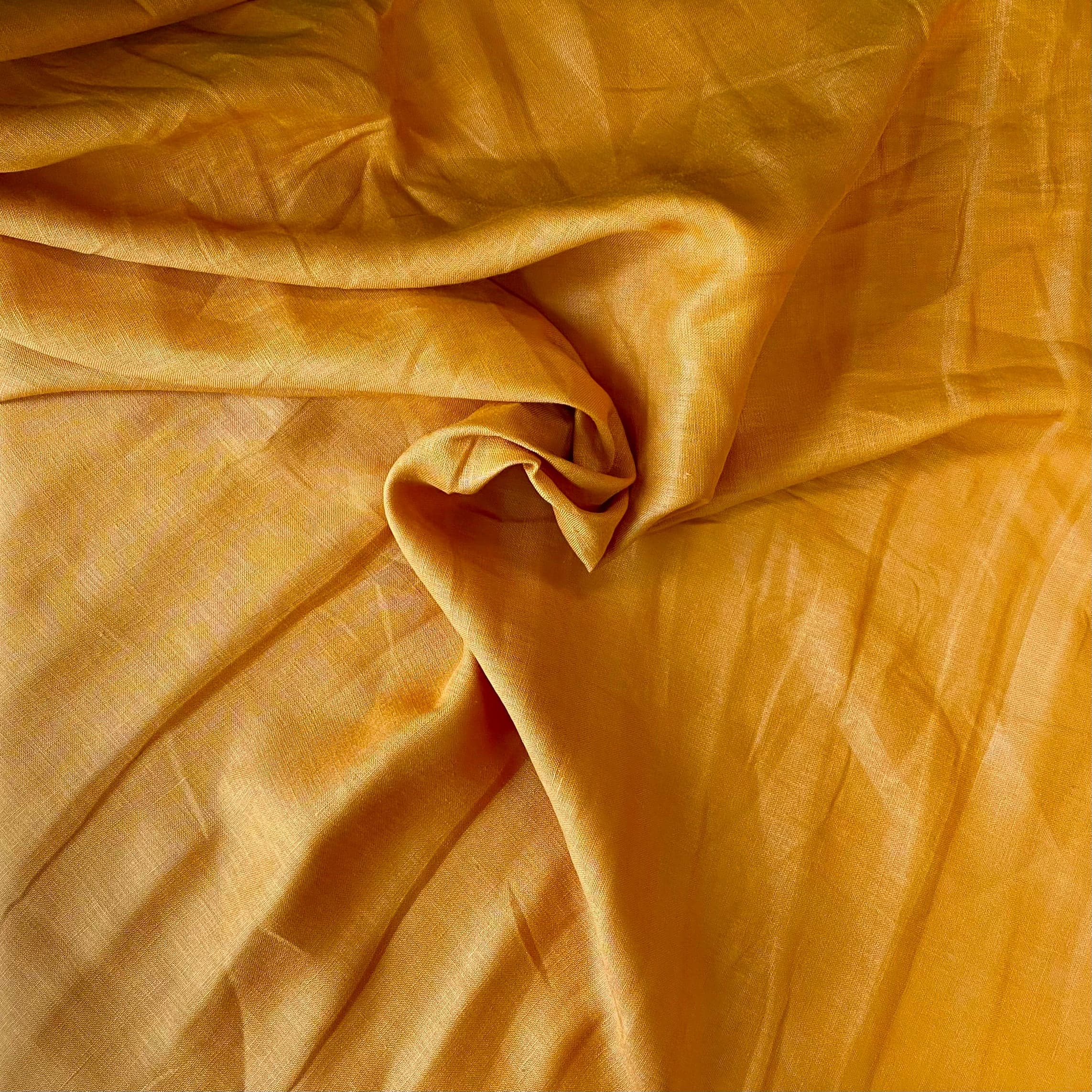 Turmeric Linen — mid-weight plain-weave linen with a slightly crisp handle that softens with wear, 100% linen, 135cm wide