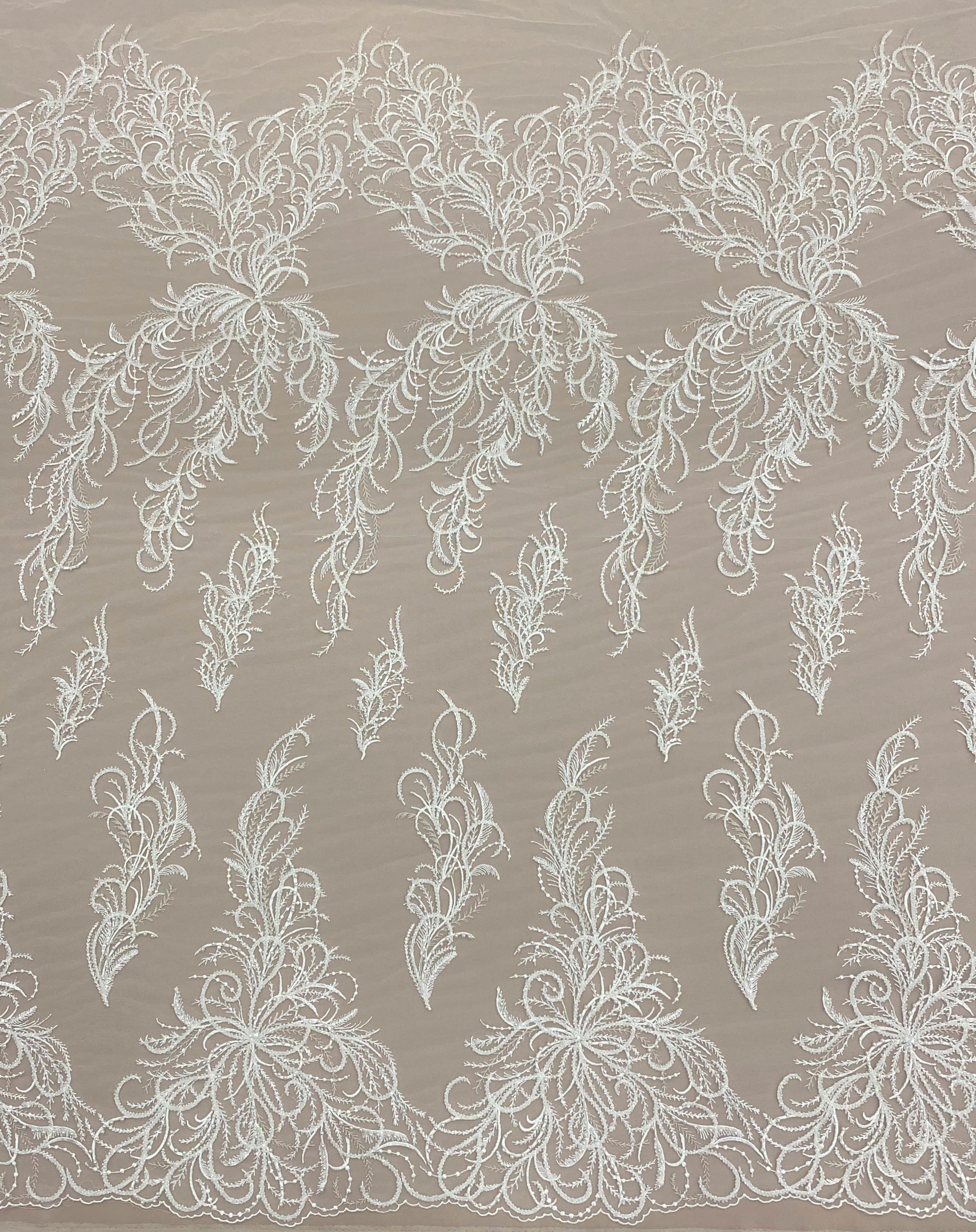 Ivory Embroidered Tulle — featuring a leaf design and hand-beading, 30% nylon 30% rayon 40% polyester, 130cm wide