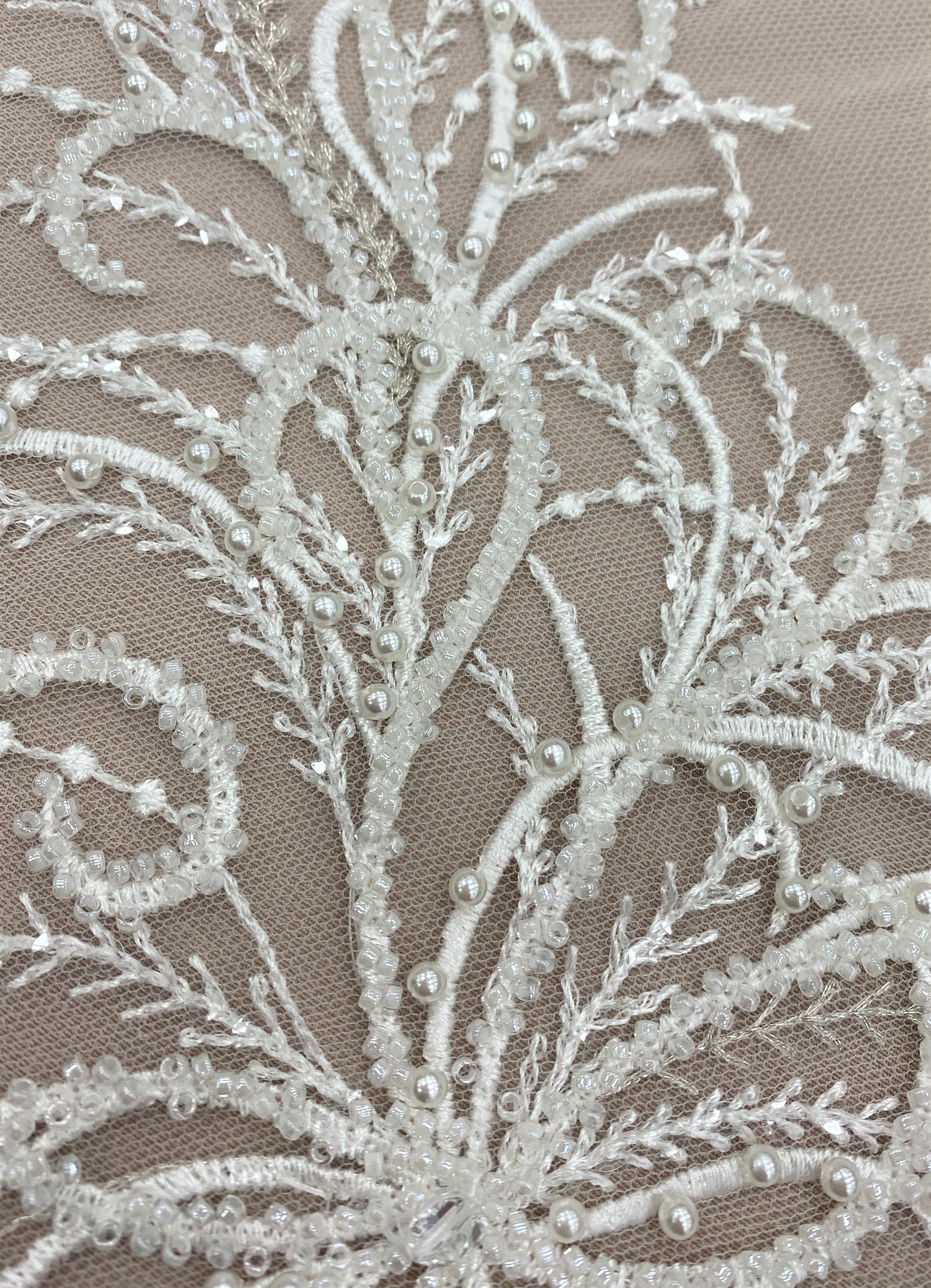 Ivory Embroidered Tulle — featuring a leaf design and hand-beading, 30% nylon 30% rayon 40% polyester, 130cm wide