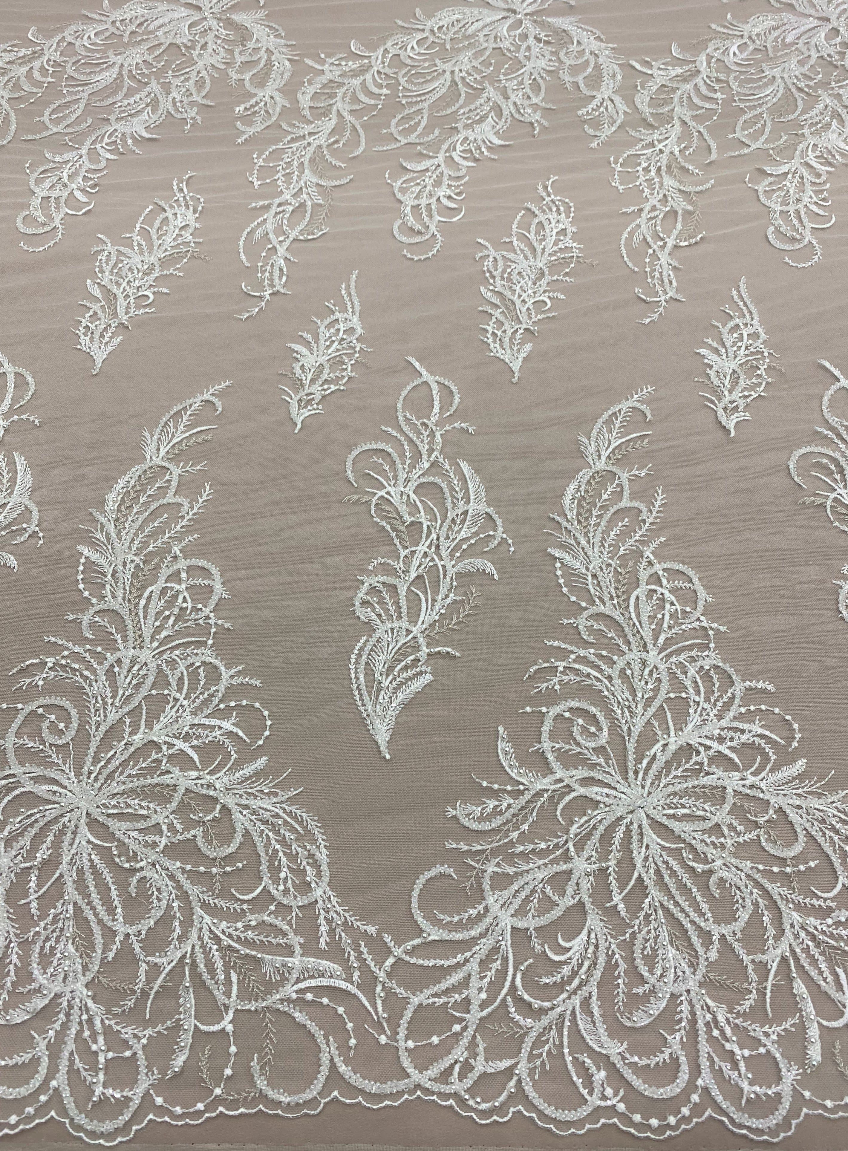 Ivory Embroidered Tulle — featuring a leaf design and hand-beading, 30% nylon 30% rayon 40% polyester, 130cm wide