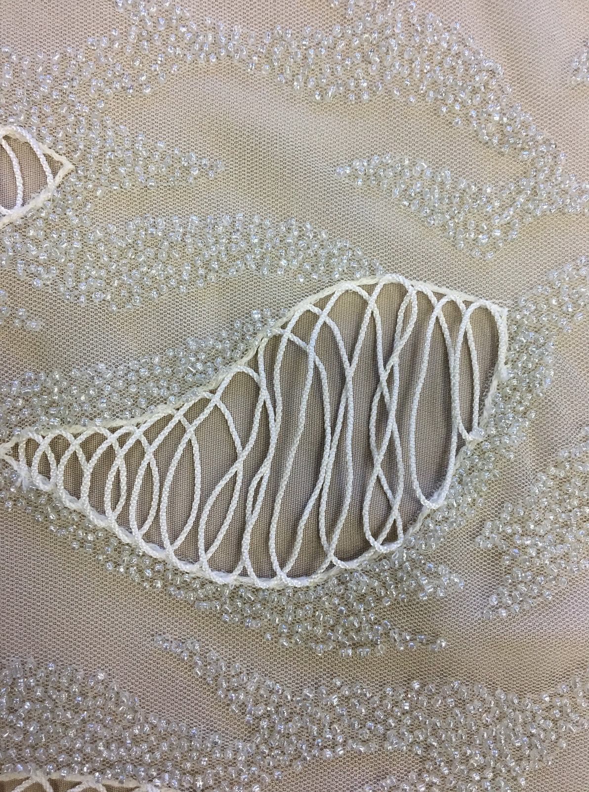 Ivory Hand Beaded Tulle — featuring a corded texture and hand-beading, 100% nylon, 110cm wide