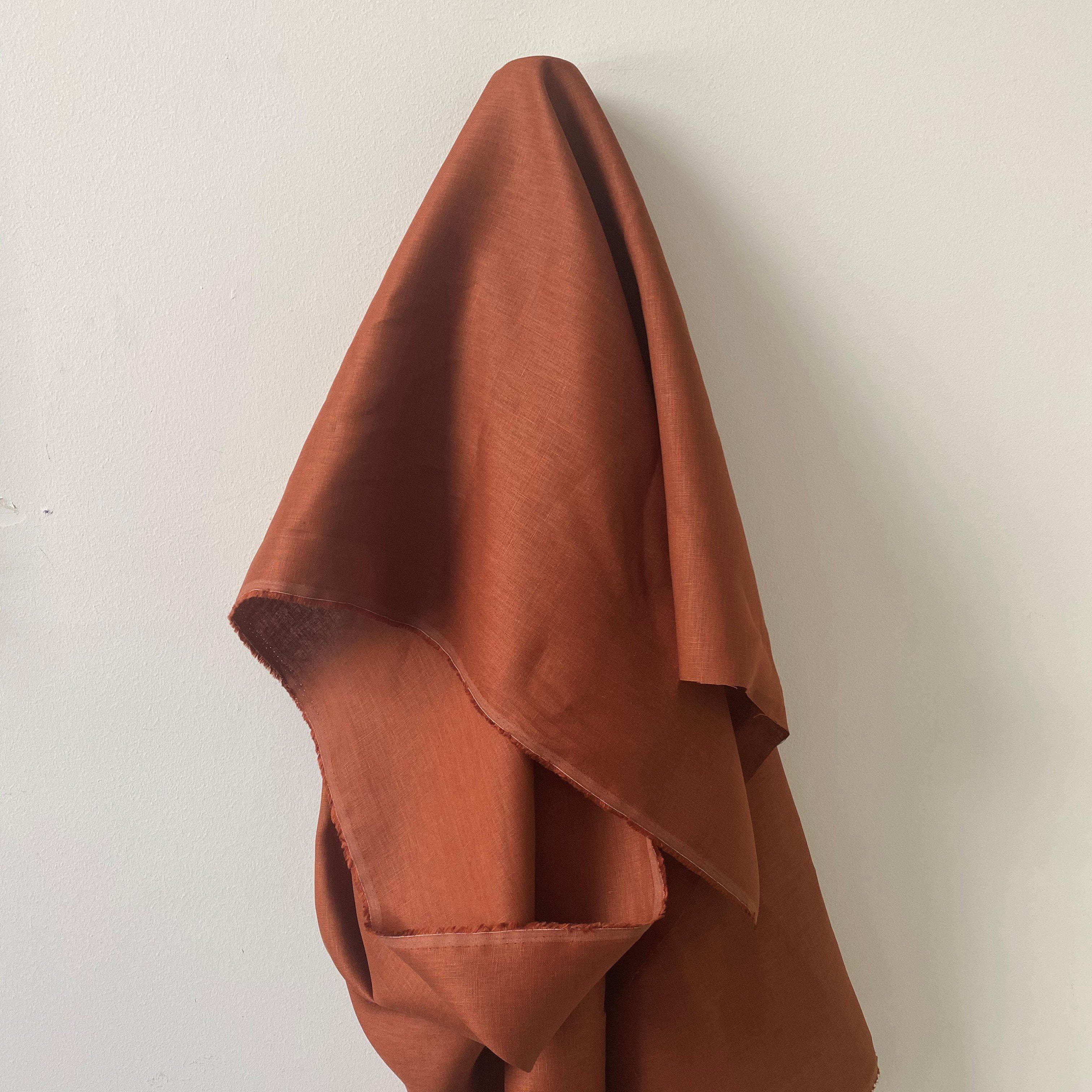 Terracotta Linen — mid-weight plain-weave linen with a slightly crisp handle that softens with wear, 100% linen, 135cm wide
