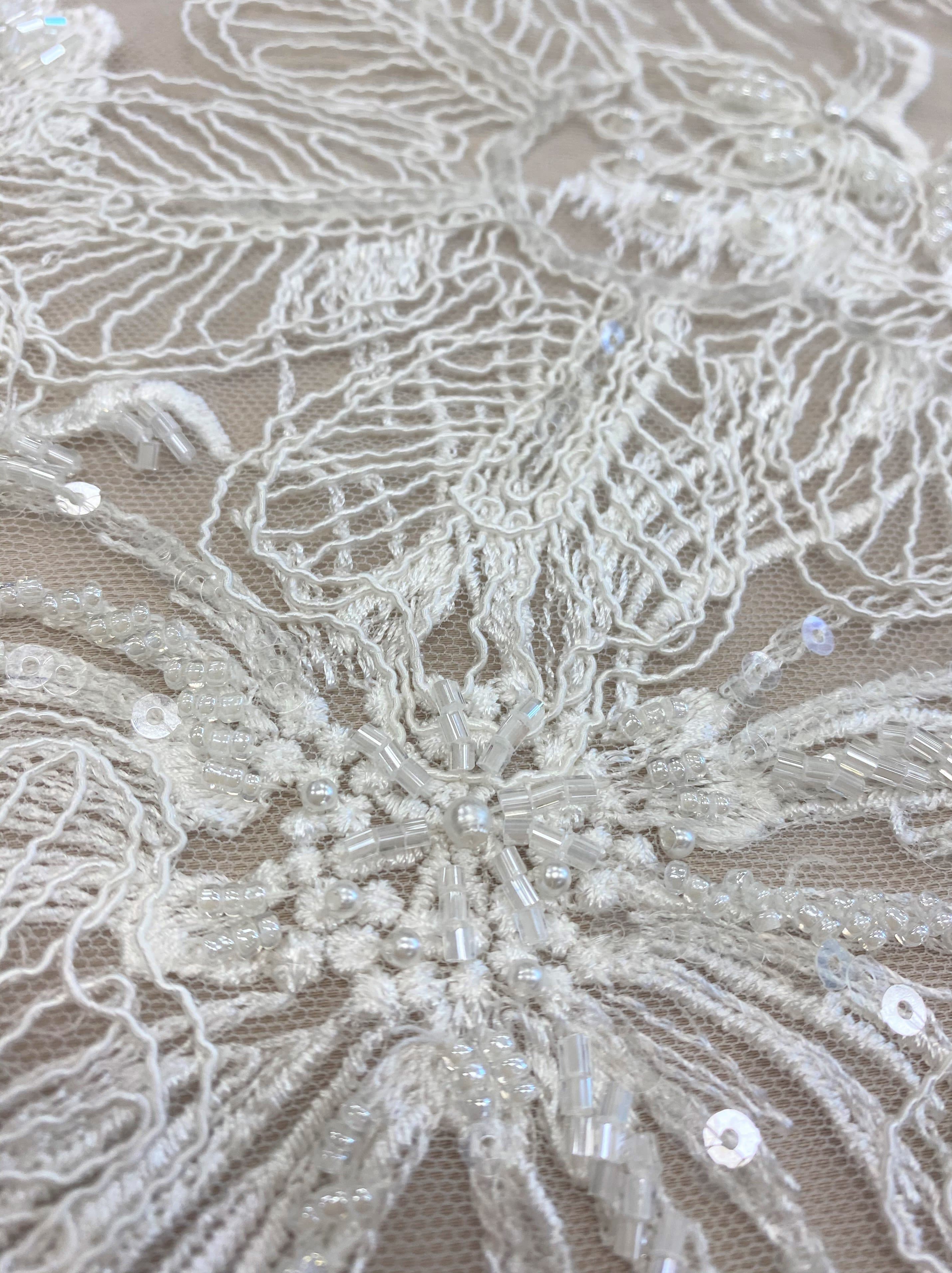 Ivory Embroidered Corded Tulle — featuring floral motifs, a corded texture and hand-beading, 50% nylon 50% rayon, 130cm wide