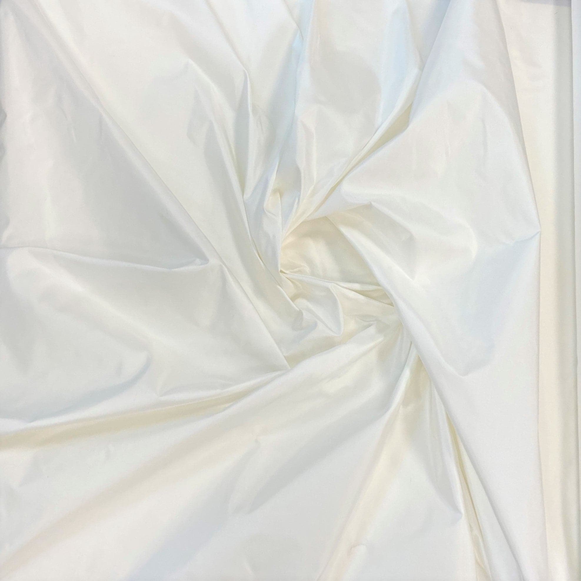 Ivory Taffeta — a mid-weight silk taffeta with a smooth texture and crisp handle, 100% silk