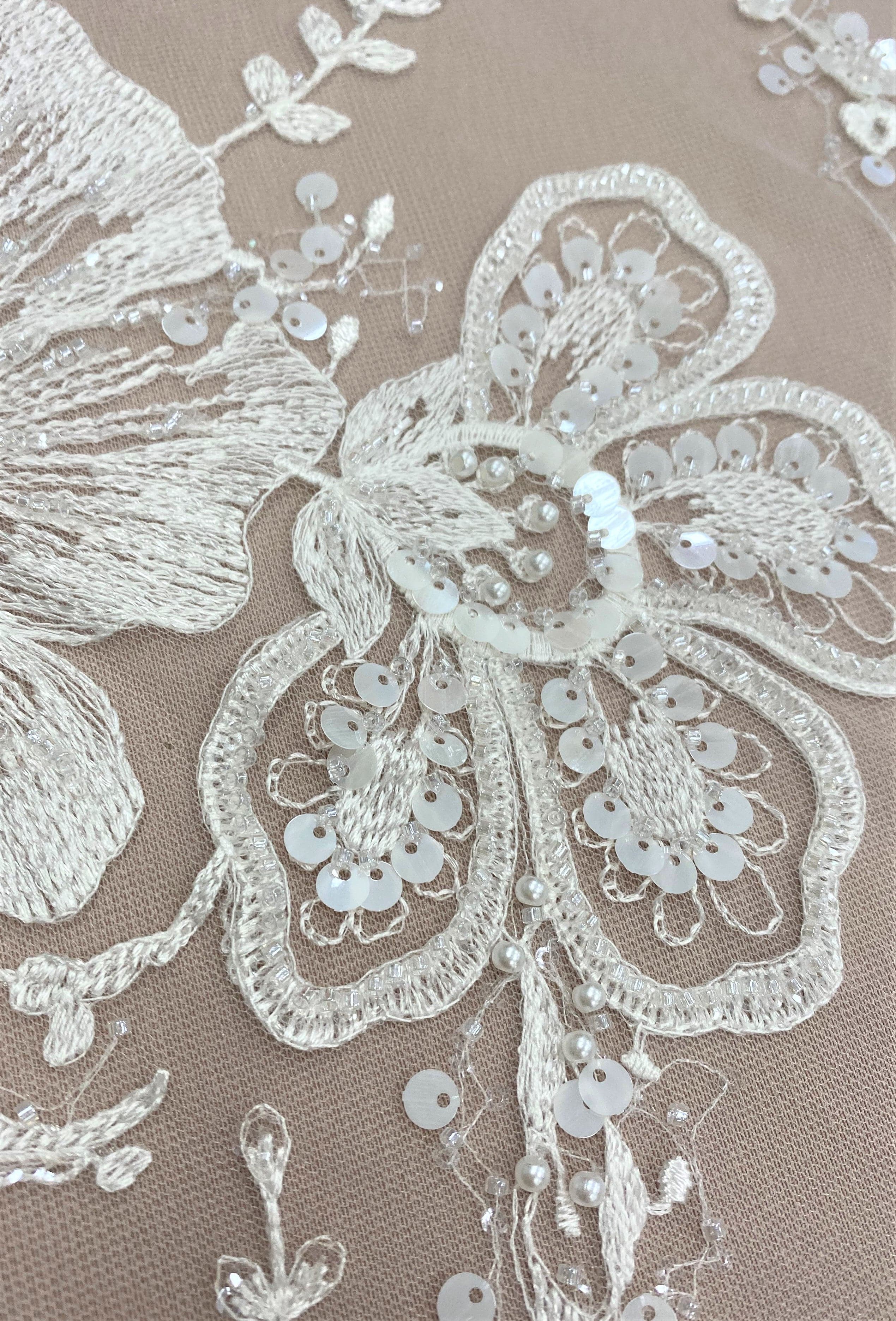 Ivory Embellished Tulle — featuring floral motifs and hand-beading, 60% rayon 40% nylon, 140cm wide