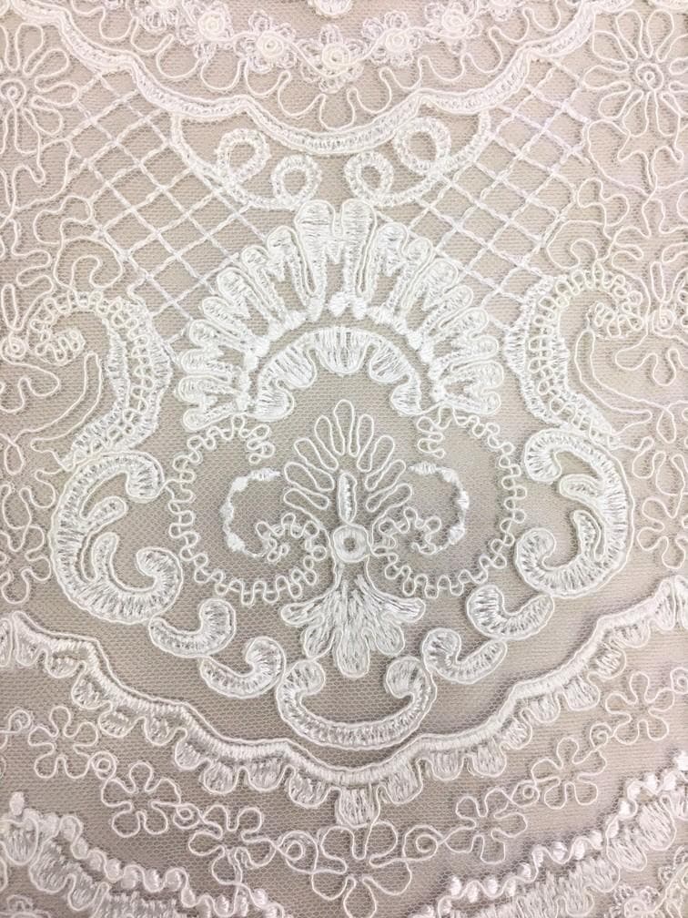 Ivory Scalloped Embroidery — featuring scalloped edges and a corded texture, 50% nylon 50% rayon, 130cm wide