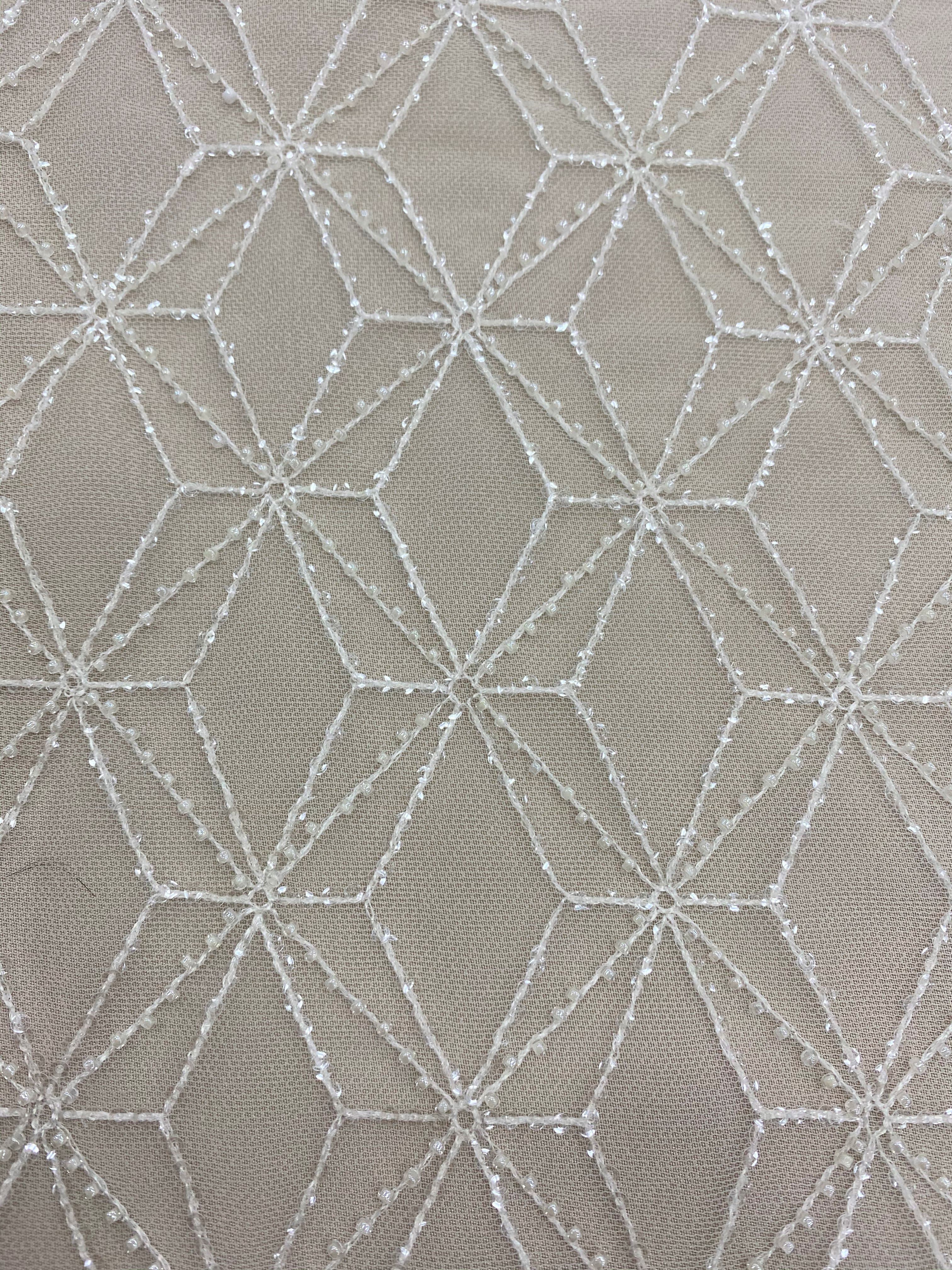 Ivory Beaded Tulle — featuring geometric motifs and hand-beading, 60% nylon 40% polyester, 130cm wide